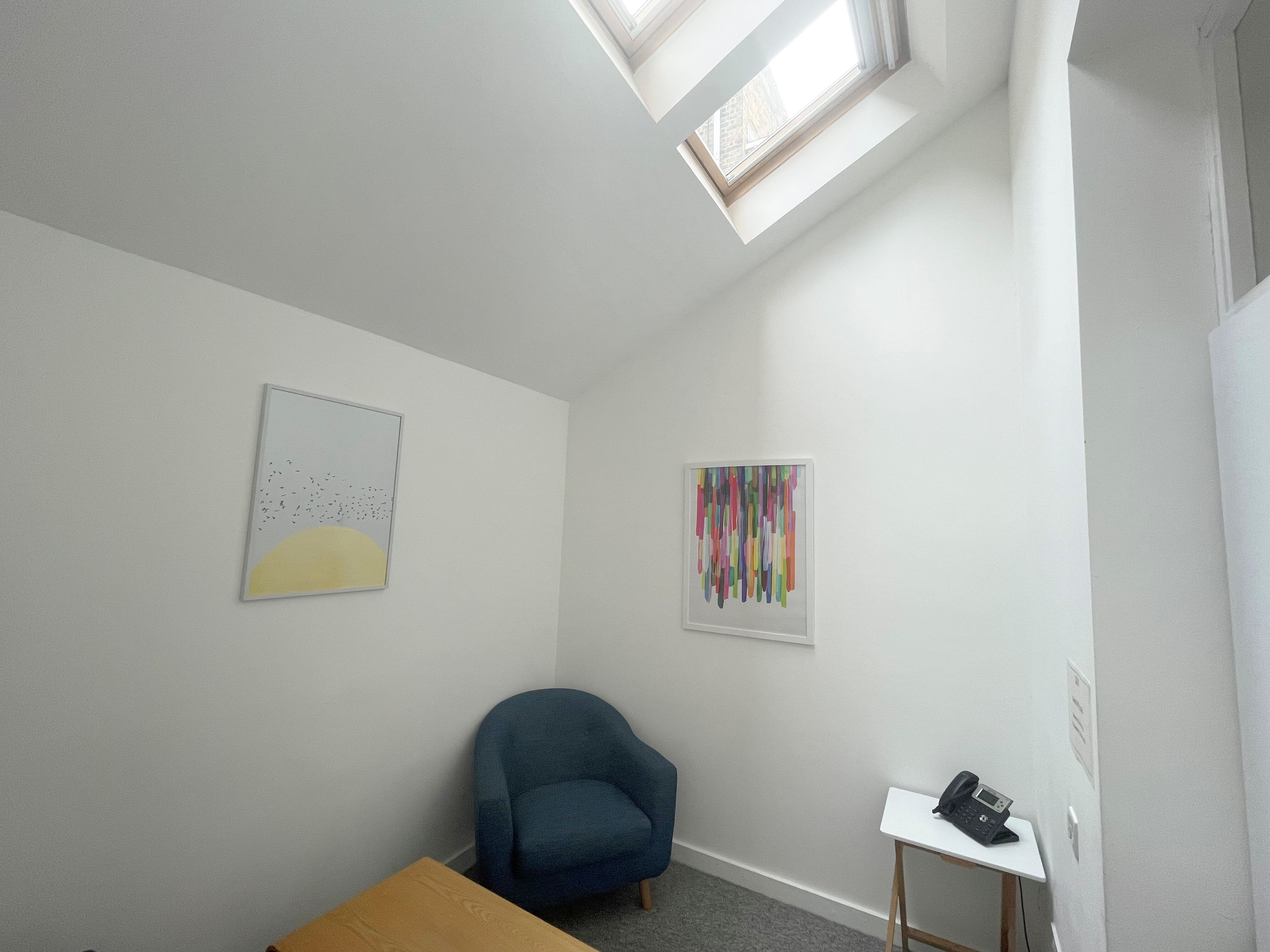 Cozy meeting room with natural light, perfect for intimate discussions and brainstorming.