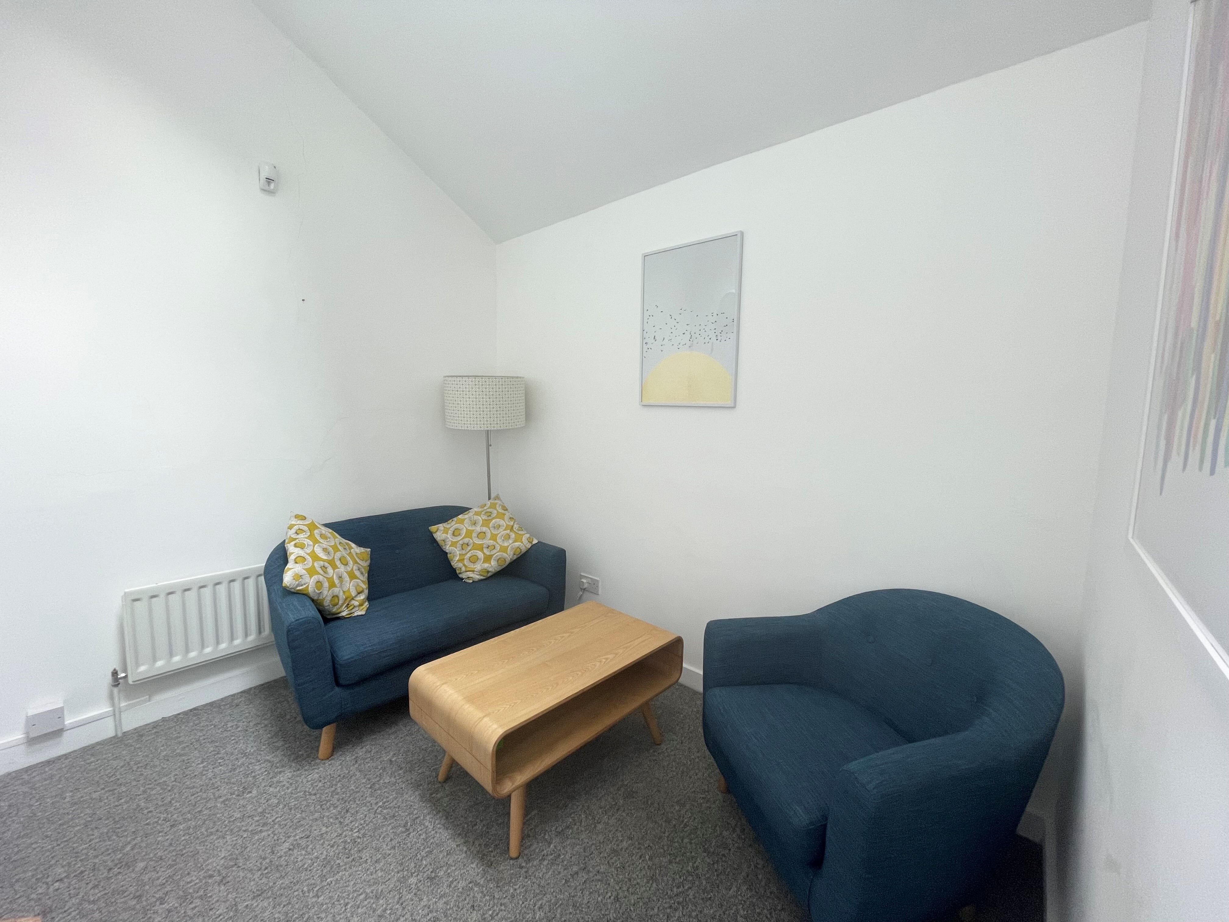 Cozy meeting room with soft seating for intimate discussions at Clean Break Studios.