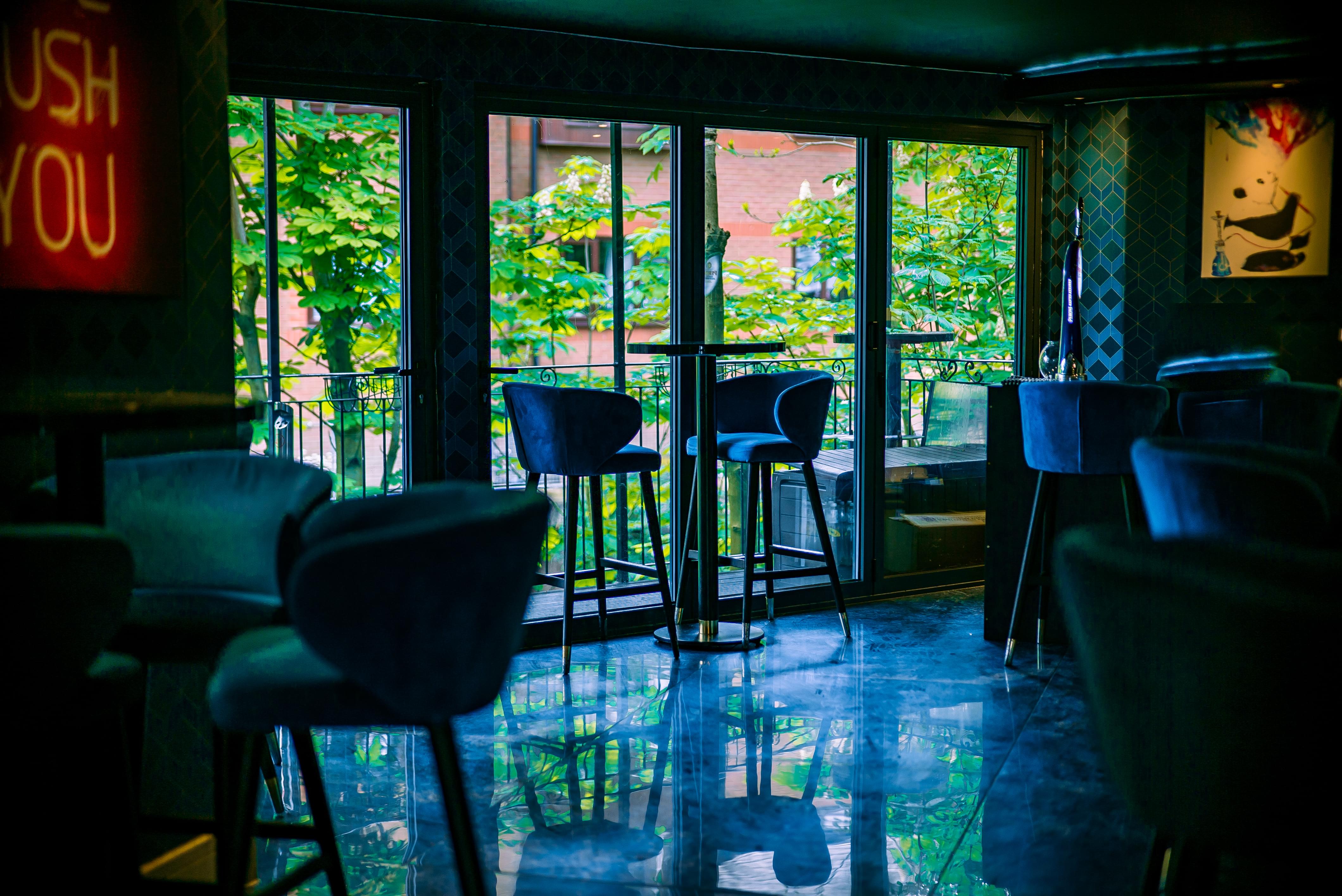 Stylish Bando Bar event space with modern stools and natural light for gatherings.