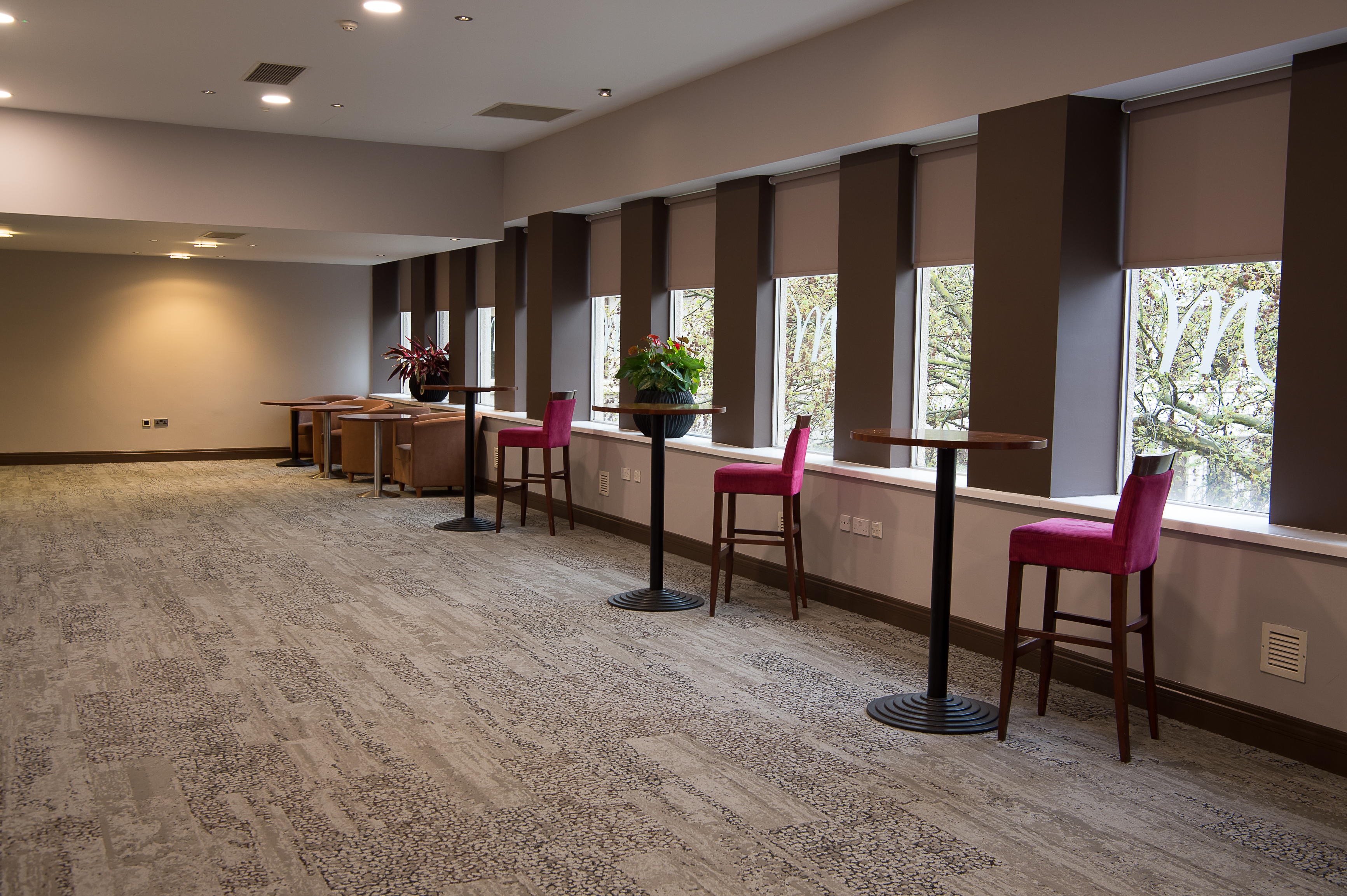 Versatile event space with high-top tables at Mercure Bristol Holland House for networking.