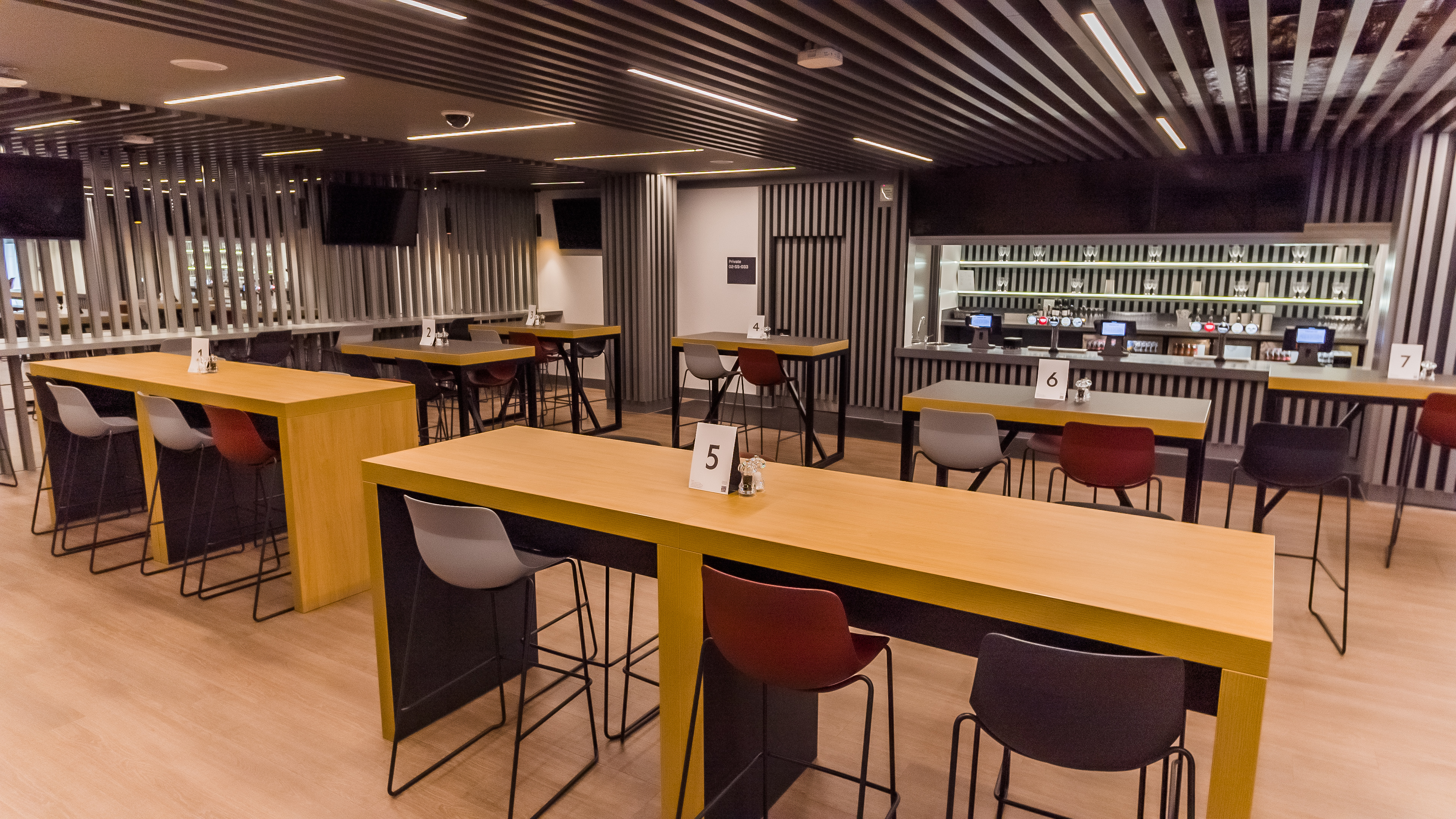 Modern event space at Brentford FC with communal tables for meetings and workshops.