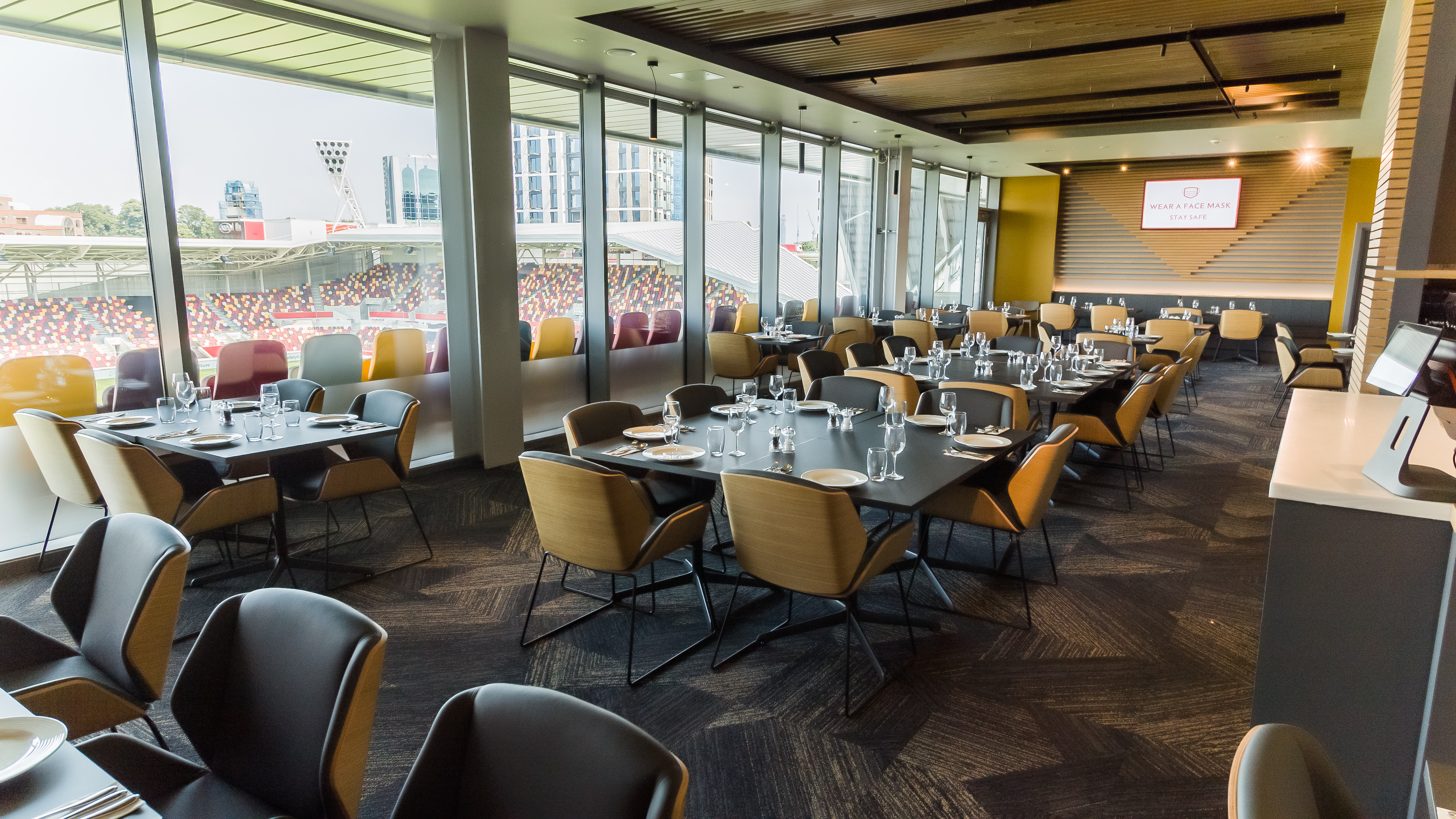 Modern event space at Brentford FC with elegant tables for corporate gatherings.