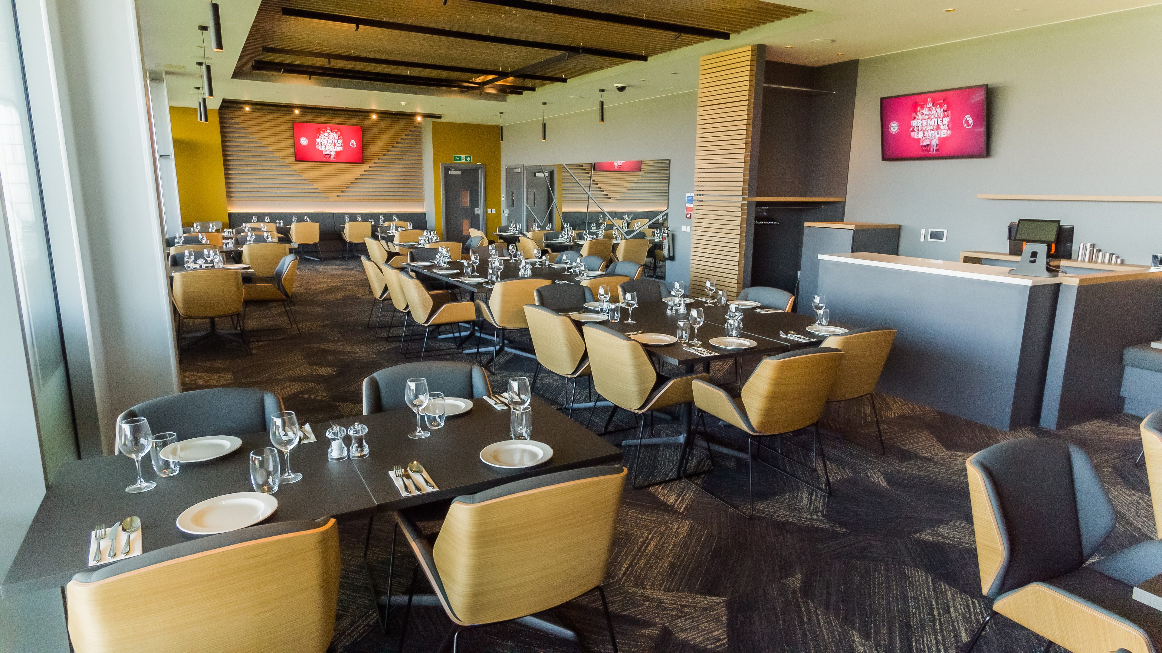 Modern event space at Brentford FC with elegant dining setup for corporate events.
