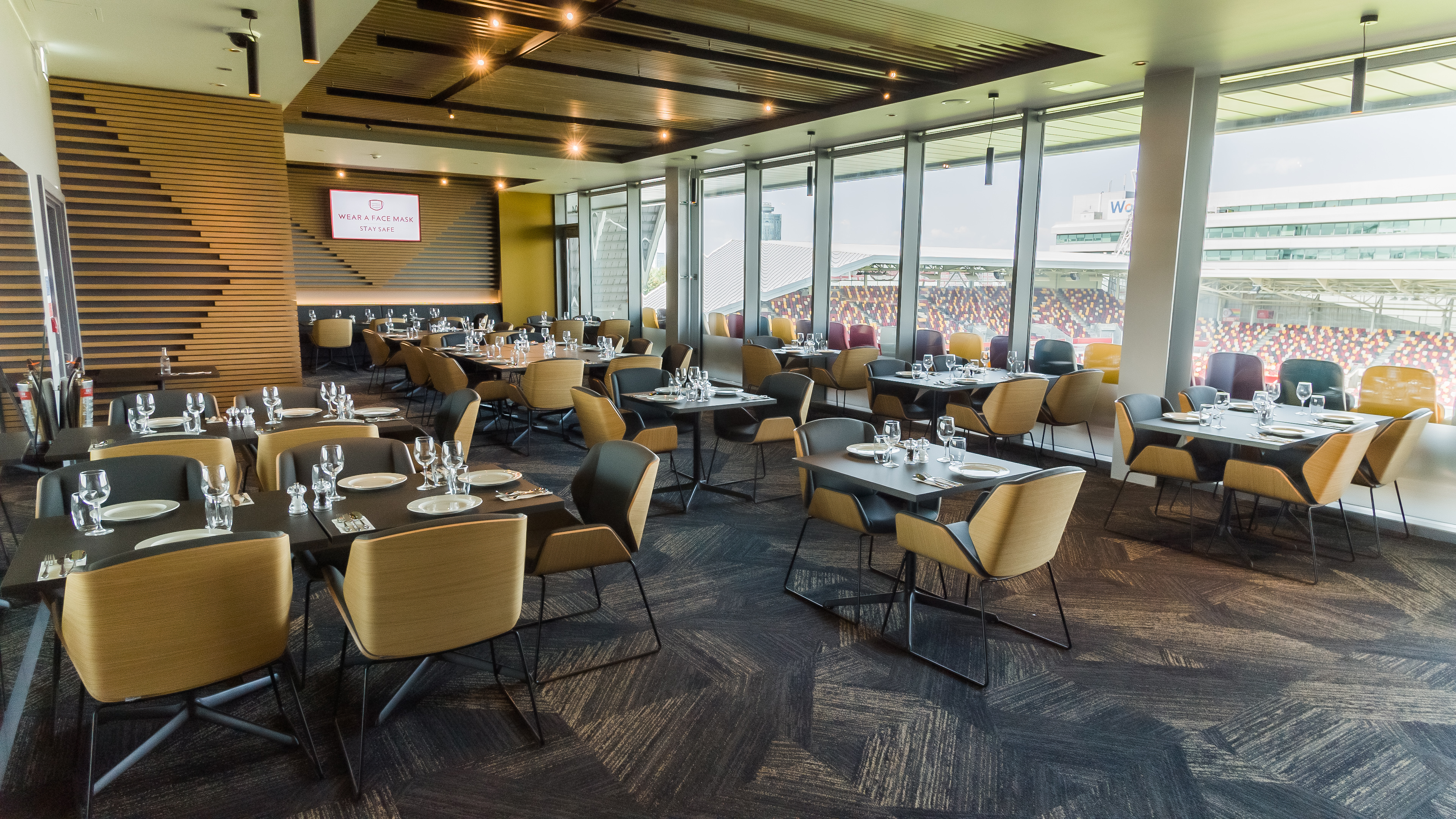 Modern event space at Brentford FC with elegant dining setup for corporate meetings.