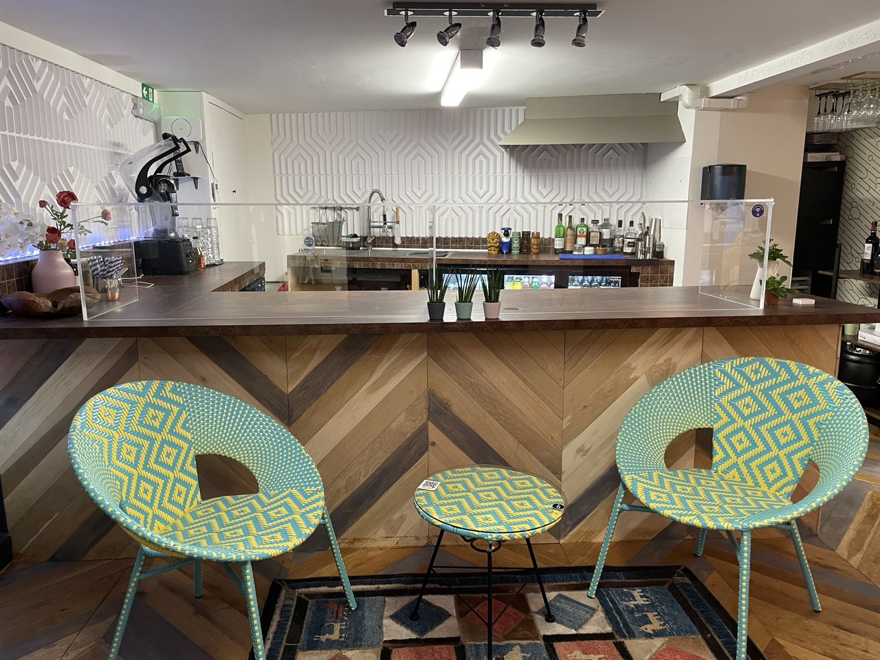 Geo Art Cafe bar area with vibrant chairs, perfect for casual networking events.