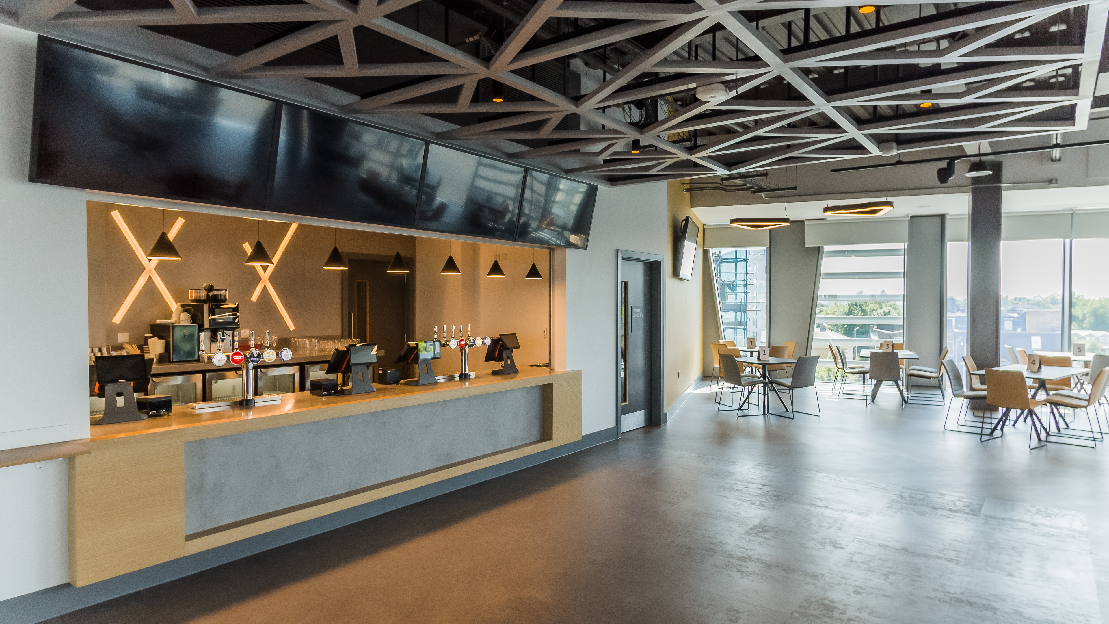 Modern event space at Brentford FC with sleek coffee bar for networking and meetings.
