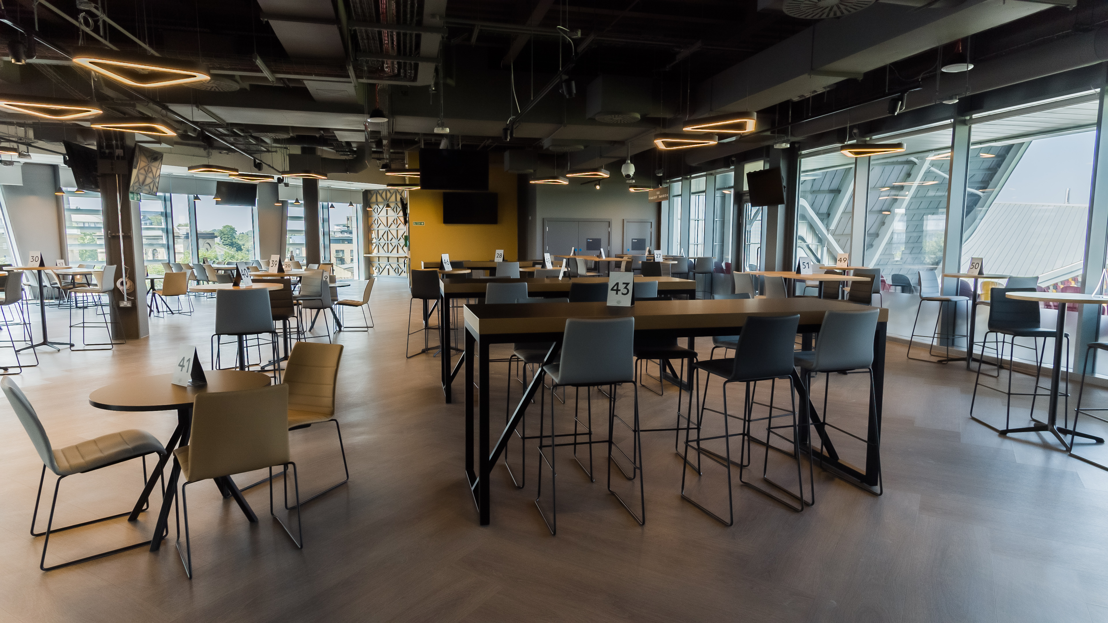 Modern event space at Brentford FC with high-top tables, ideal for networking events.