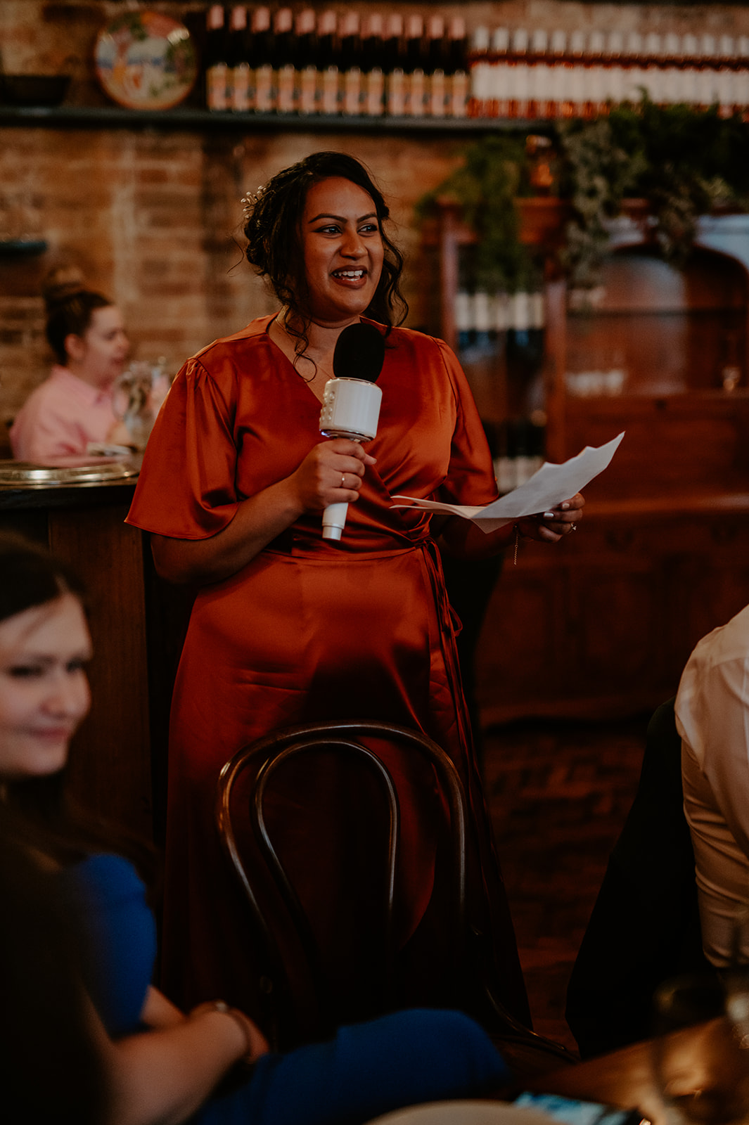 Confident speaker with microphone at Casa do Frango corporate event.