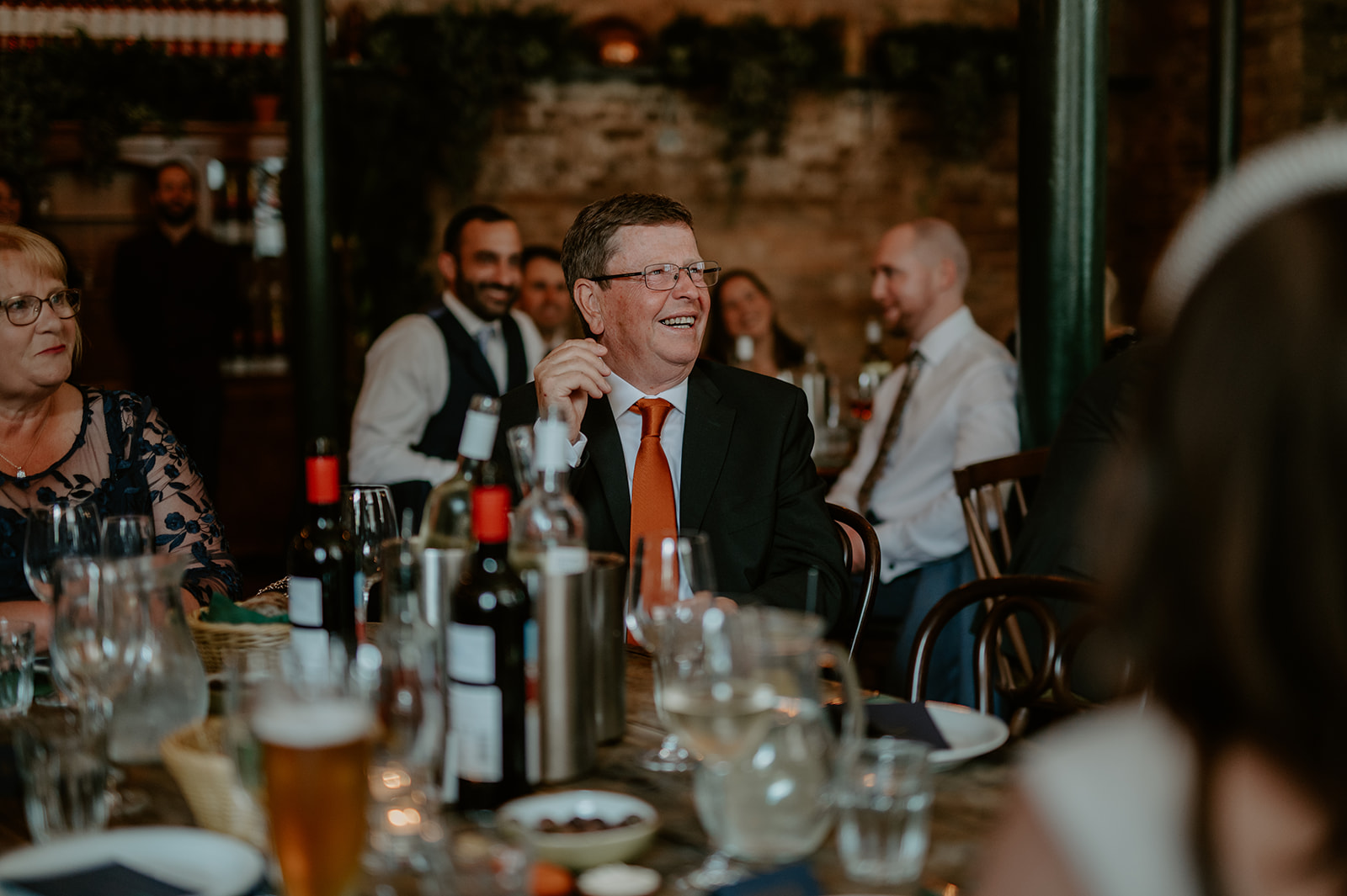 Lively event at Casa do Frango with guests enjoying a toast and warm decor.