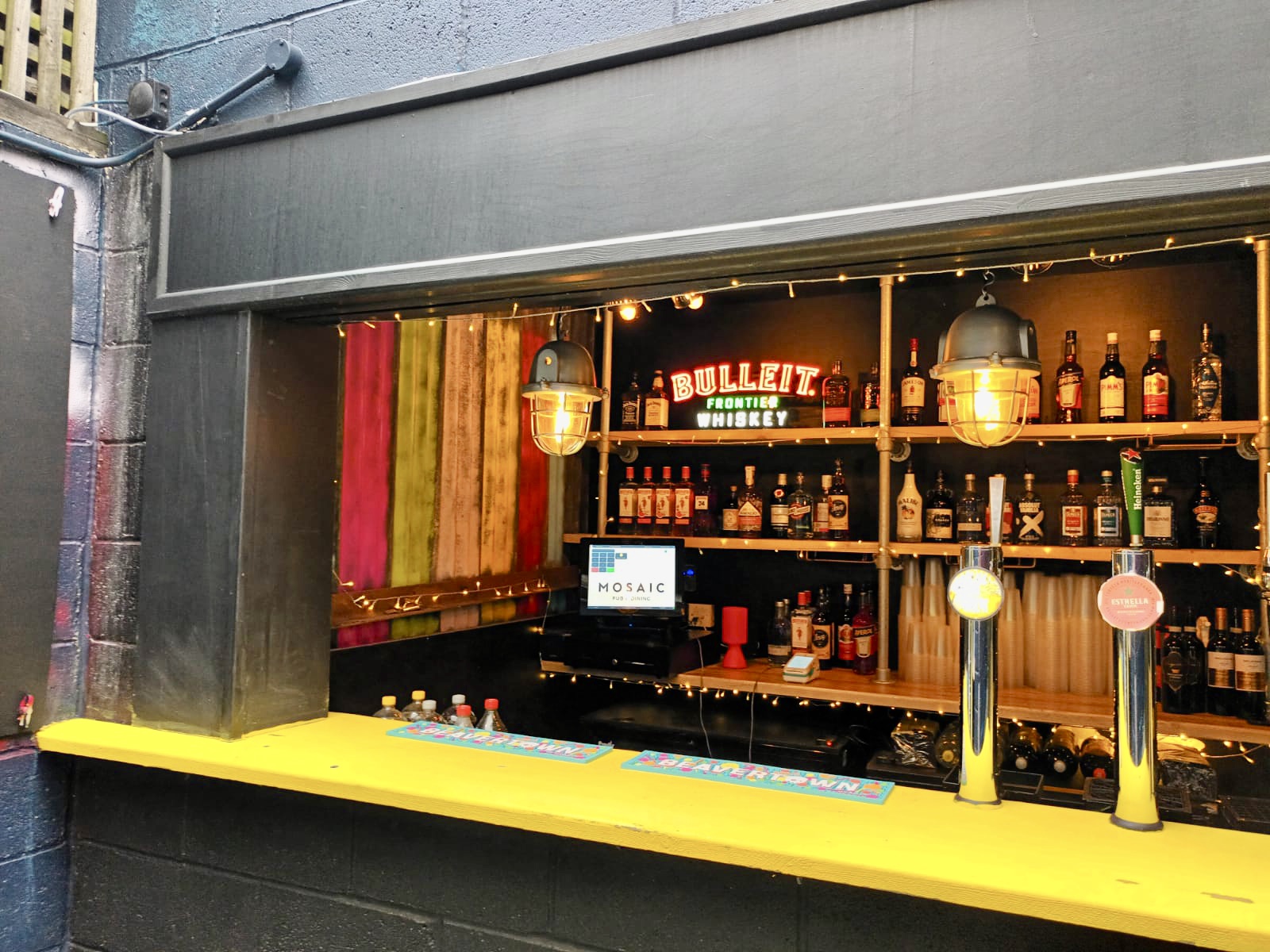 Vibrant bar setup at The Yard, ideal for events and socializing in a welcoming atmosphere.