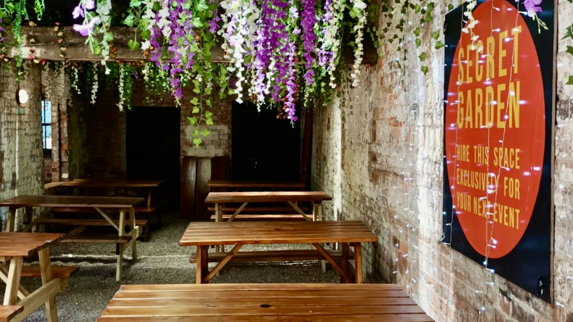 Charming event space with rustic tables and floral decor for intimate gatherings.