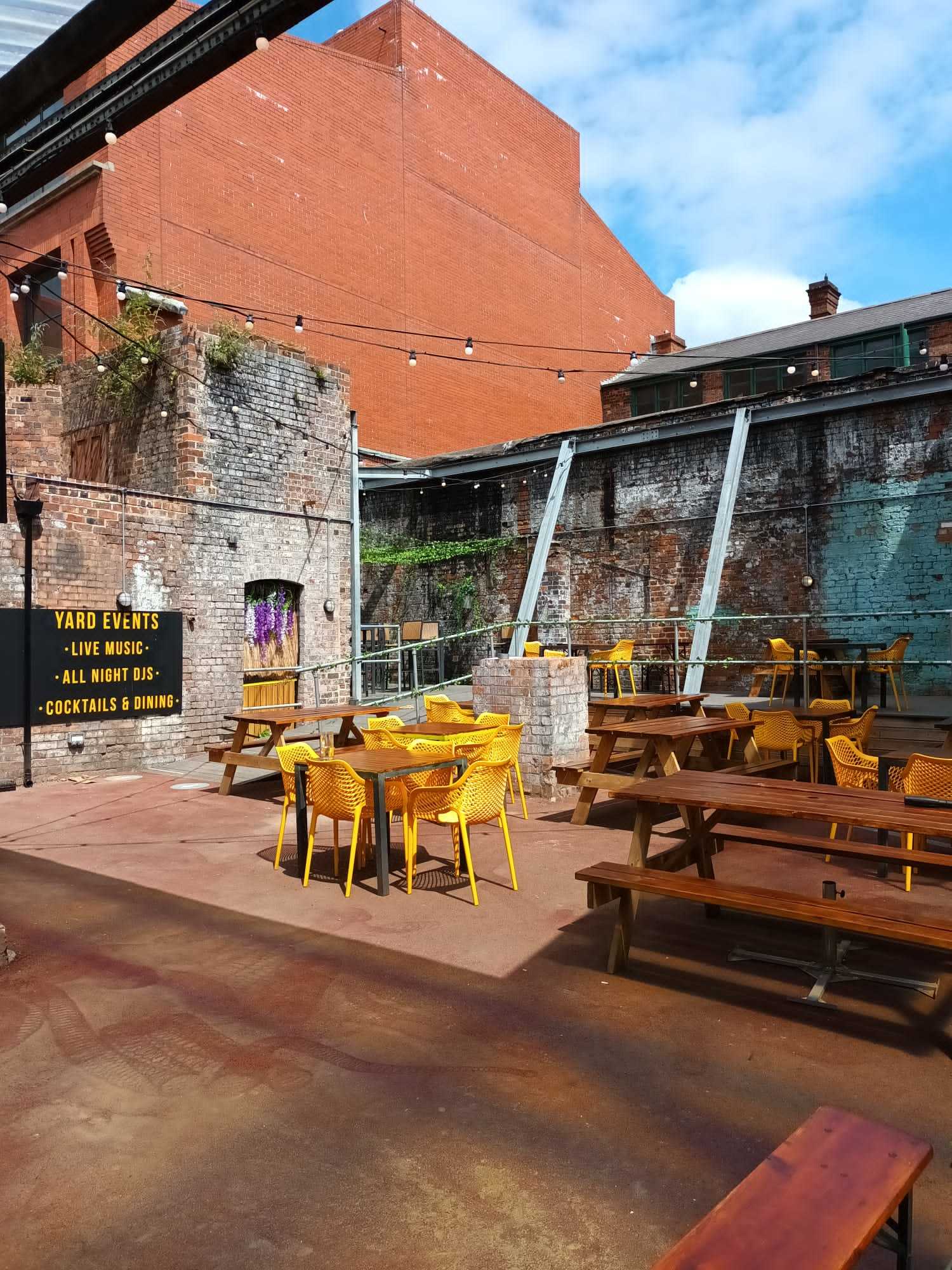 Vibrant outdoor event space with yellow seating, ideal for cocktail parties and gatherings.