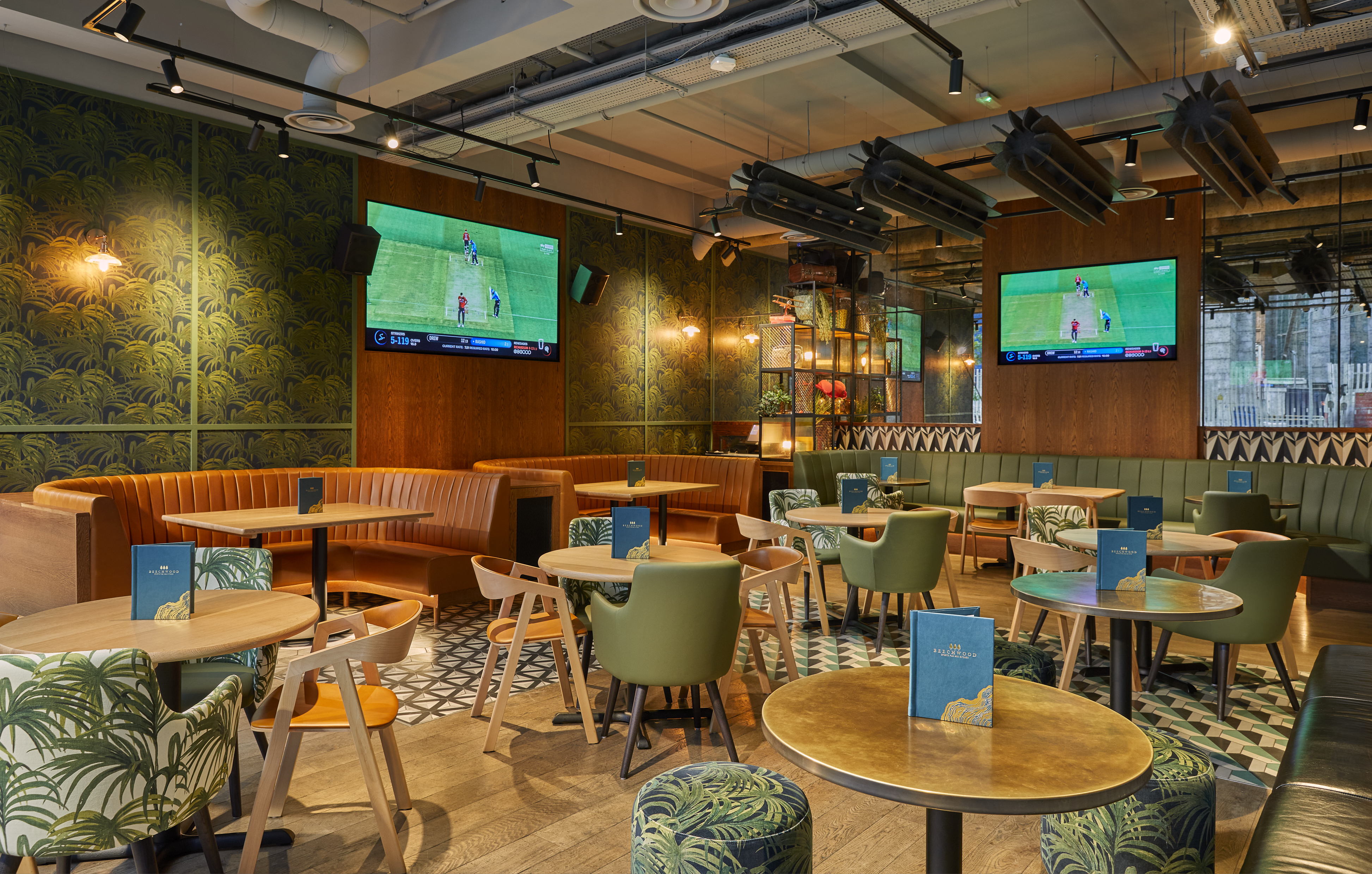 Stylish Beechwood Sports Pub venue for casual meetings and events with dual screens.