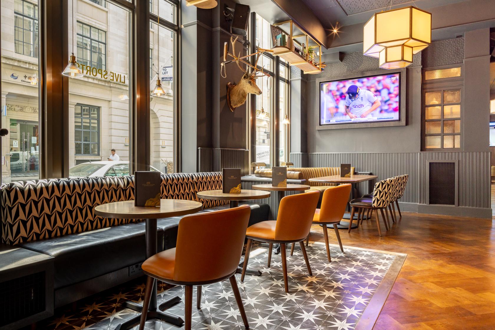 Stylish Oval Bar in Goldwood Spots Pub, ideal for events and gatherings.