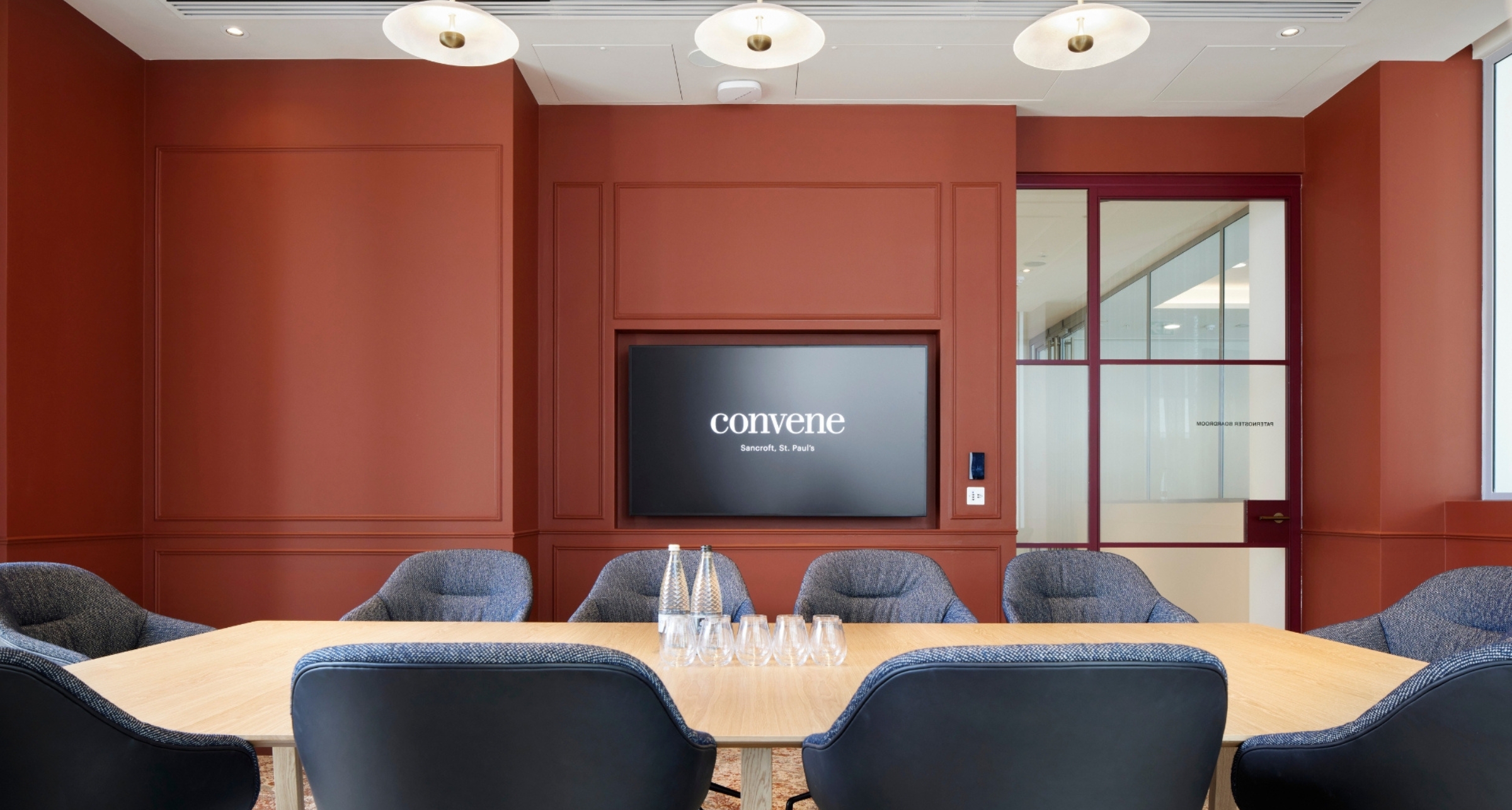 Modern meeting room at Convene Sancroft, St Pauls with sleek table and large screen.