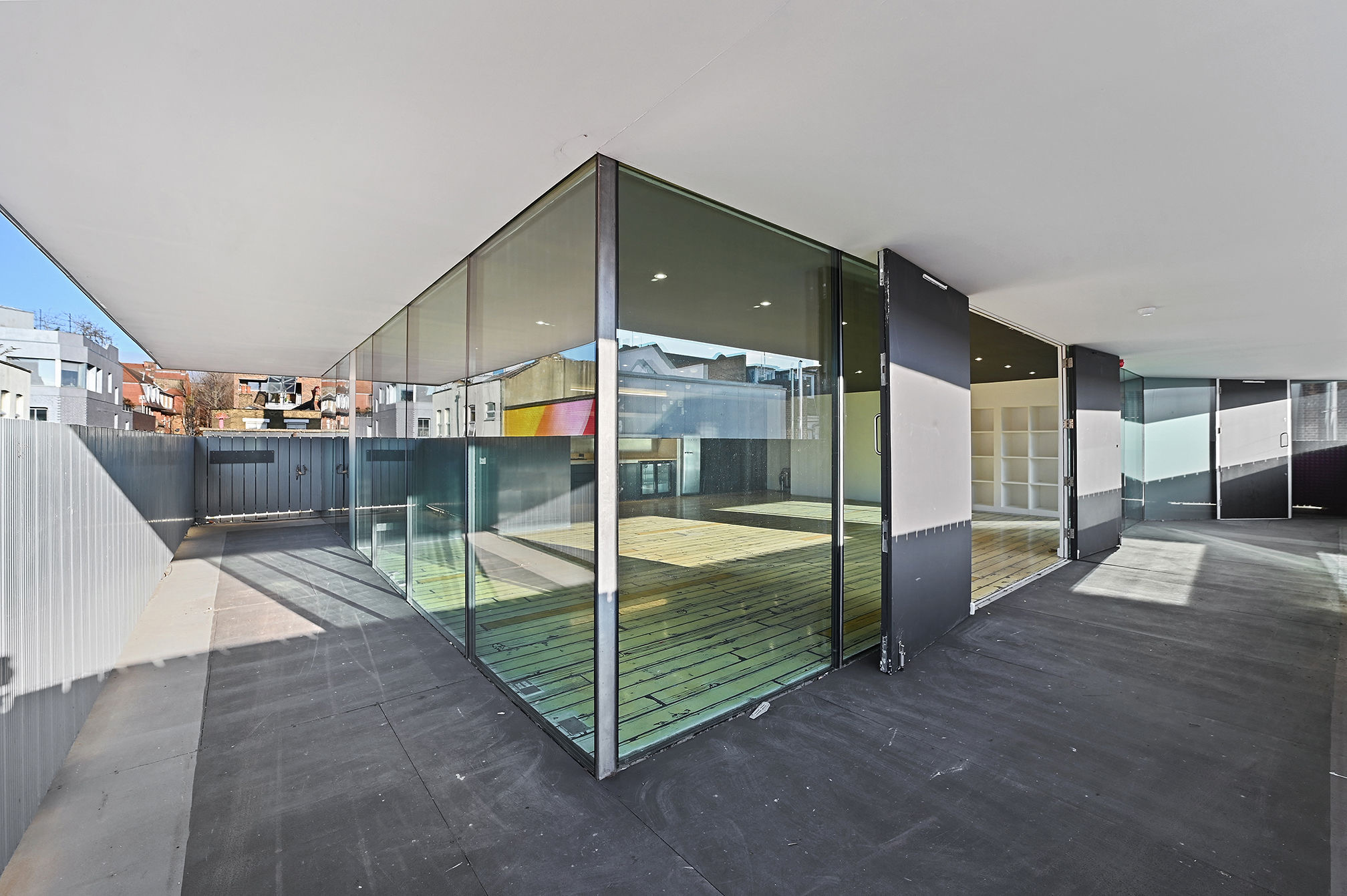 Modern event space with glass walls, ideal for corporate meetings and social gatherings.