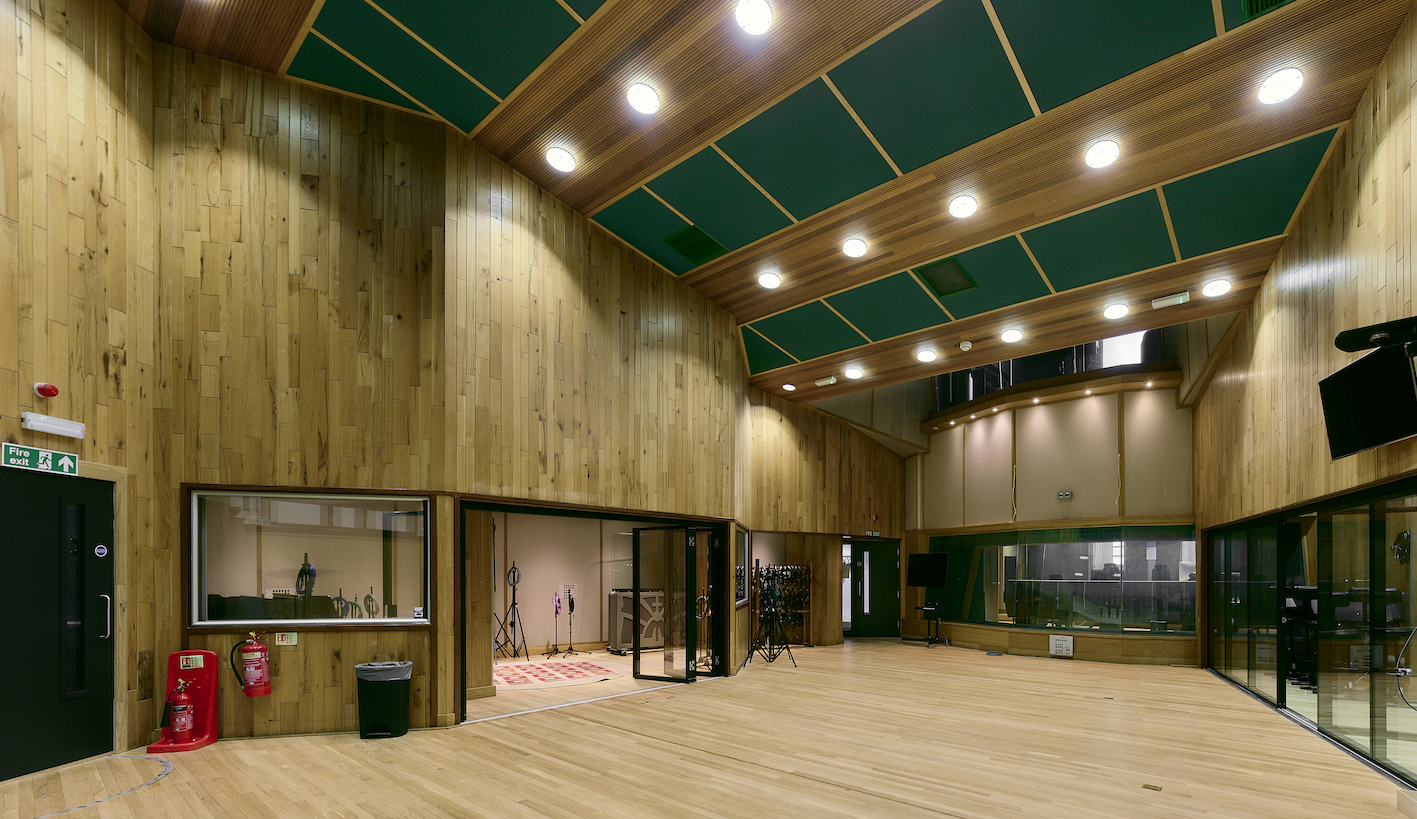 Spacious Angel Studios venue with wooden paneling, ideal for meetings and workshops.