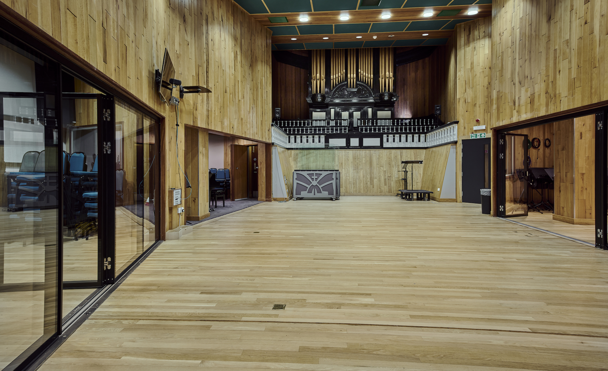 Spacious Angel Studios venue with wooden walls, ideal for meetings and performances.