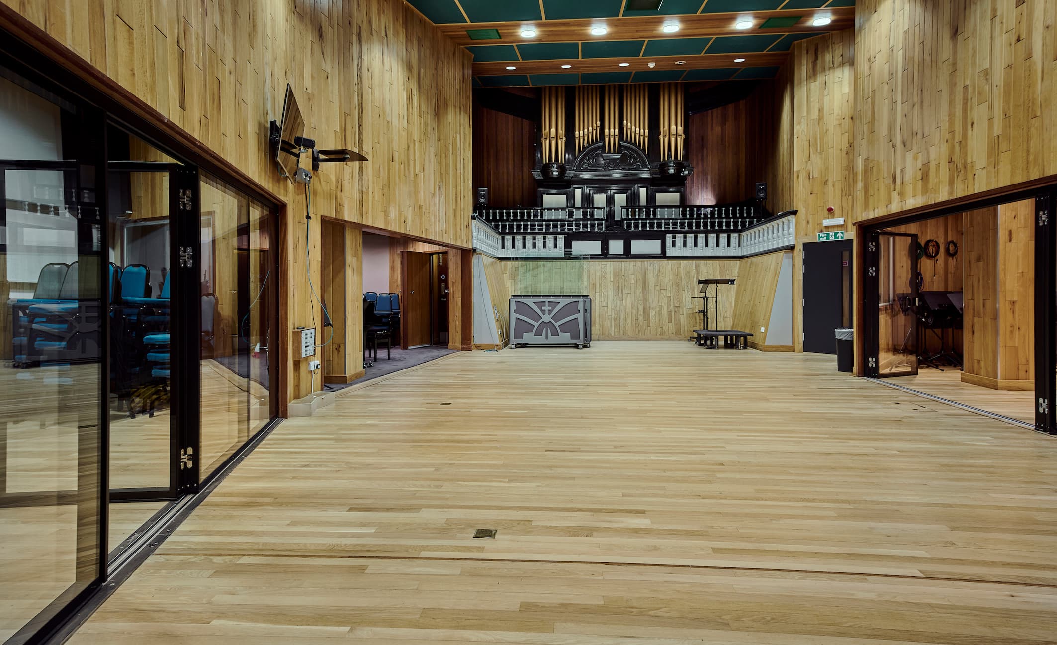 Spacious Angel Studios venue with wooden walls, ideal for meetings and performances.