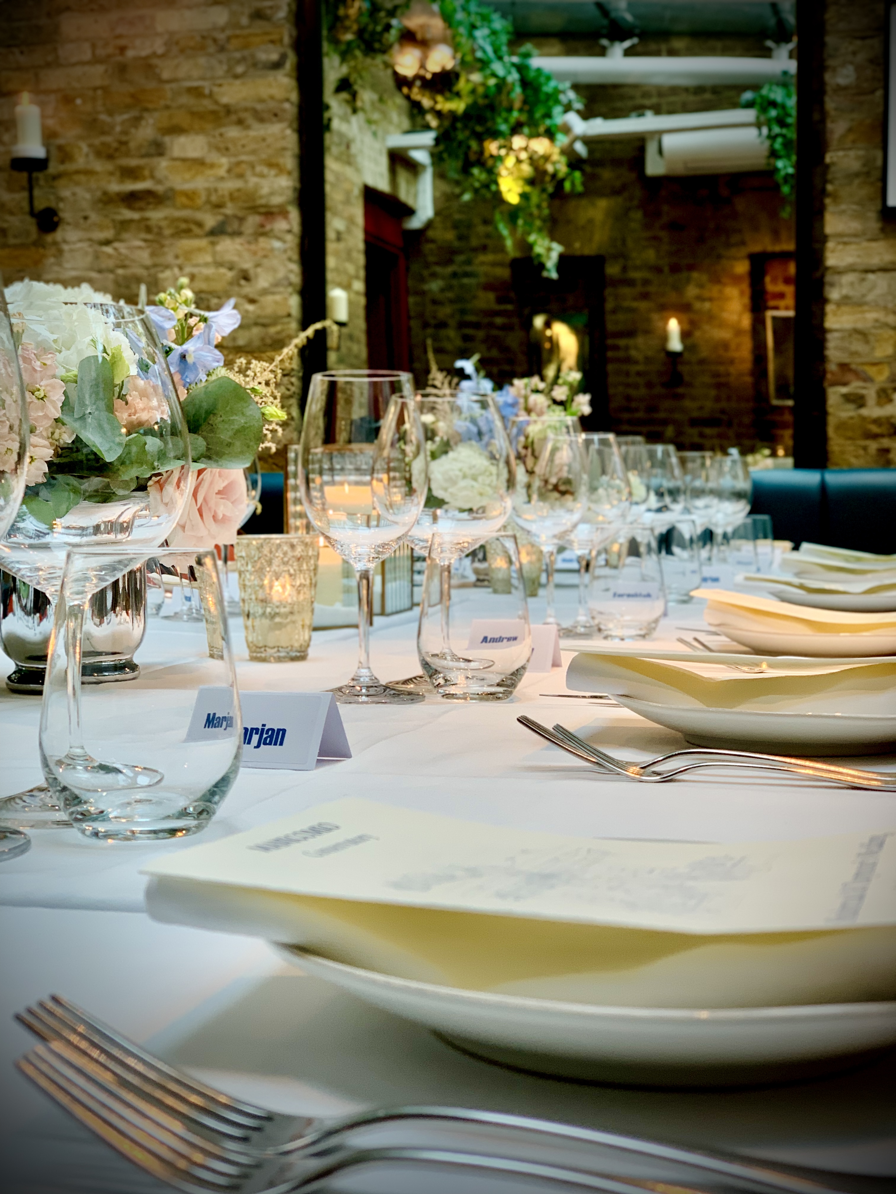 Elegant dining table at Manicomio Chelsea for a sophisticated event with floral centerpieces.
