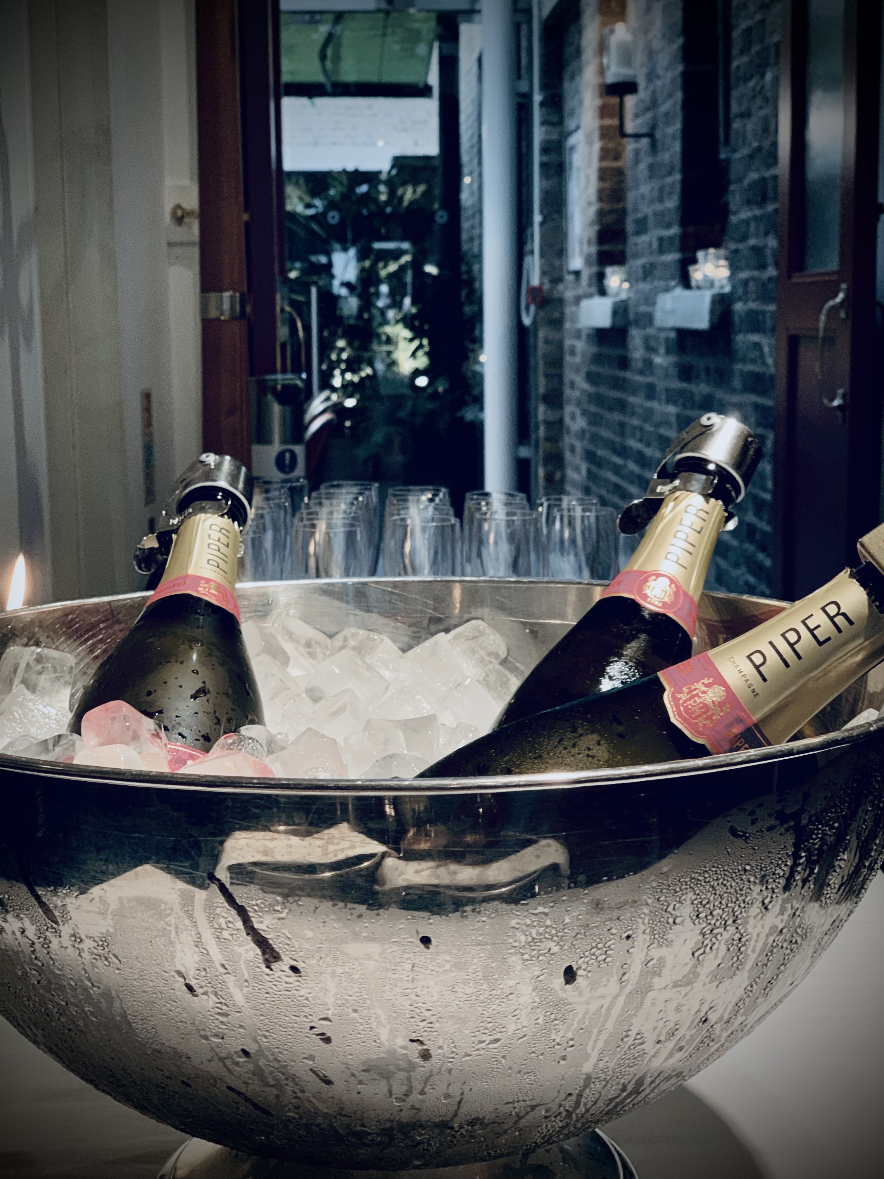 Stylish ice bucket with champagne for elegant events at Manicomio Chelsea Restaurant.