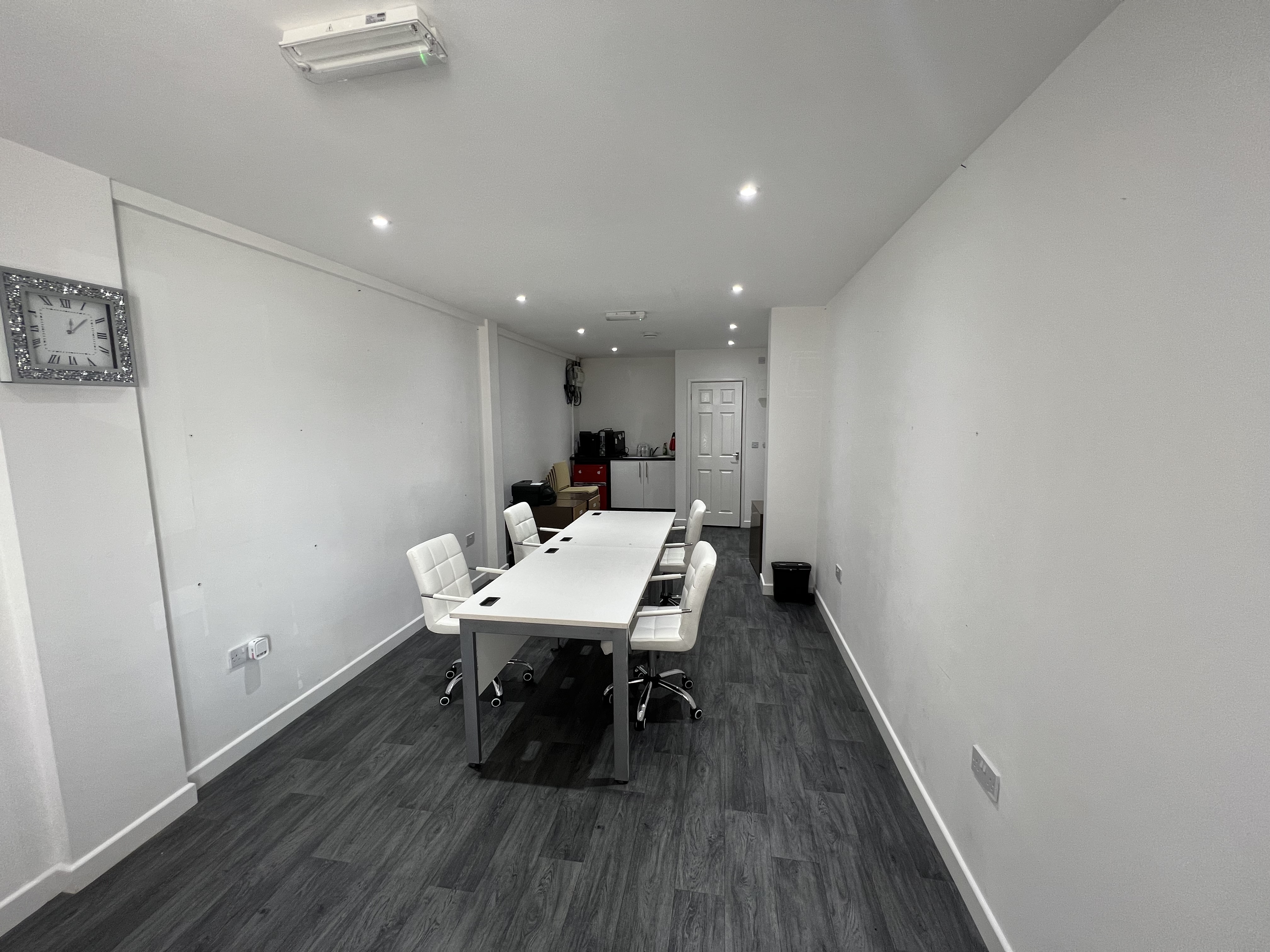 Modern meeting room with white table, ideal for presentations and discussions in Strood.