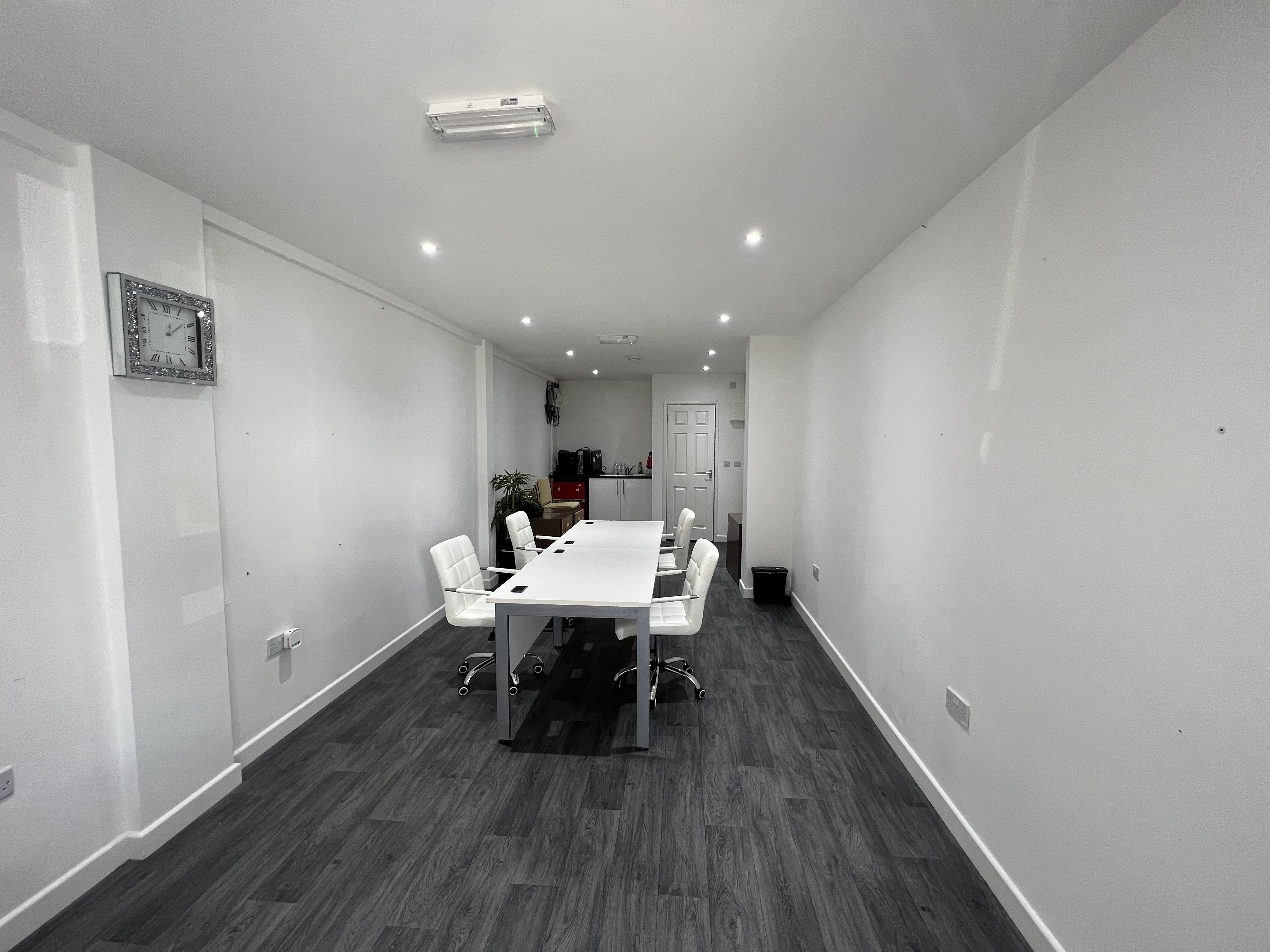Modern meeting room in Strood with white table, ideal for workshops and discussions.