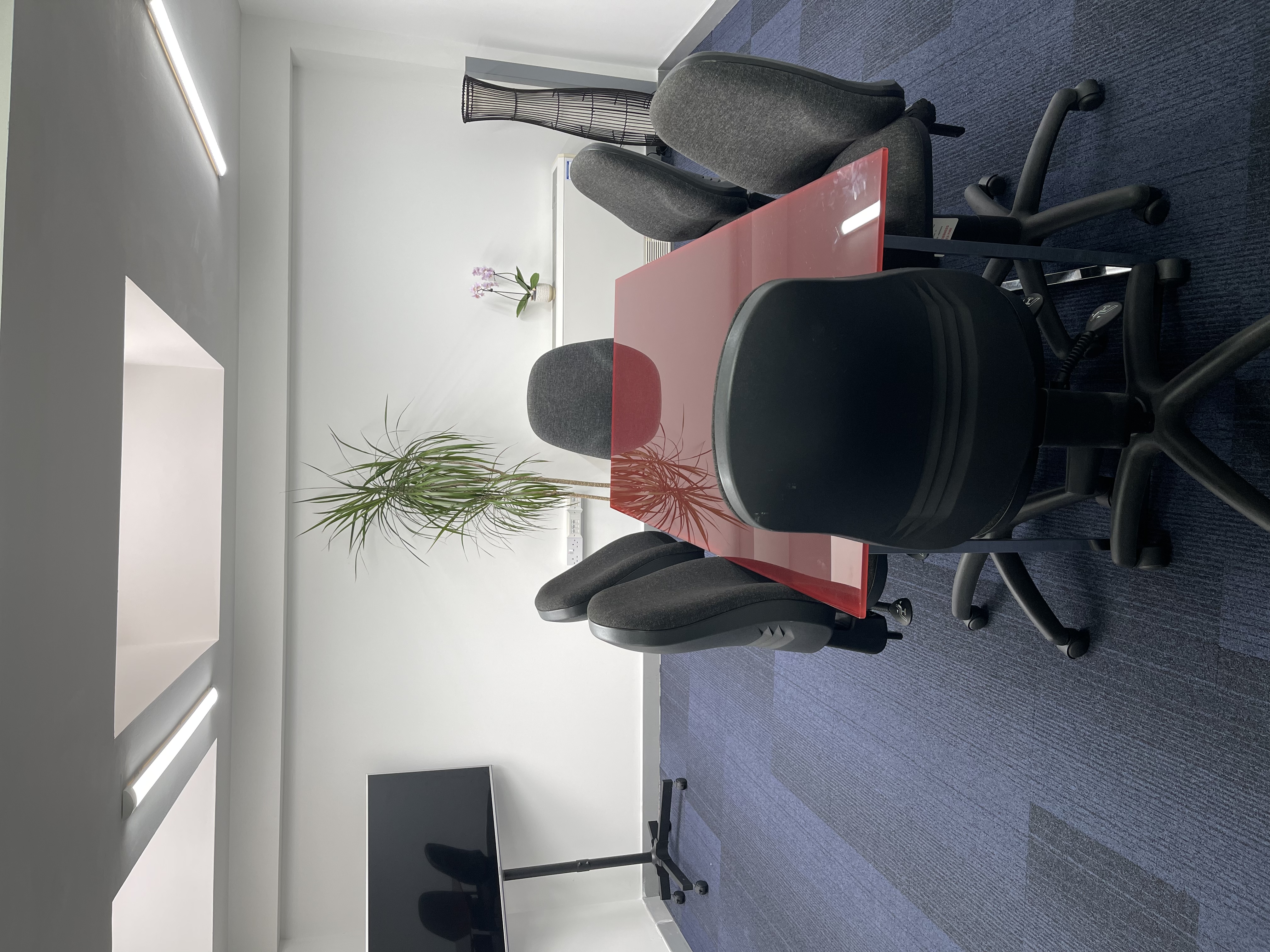 Modern meeting room with polished table, ideal for presentations and conferences.