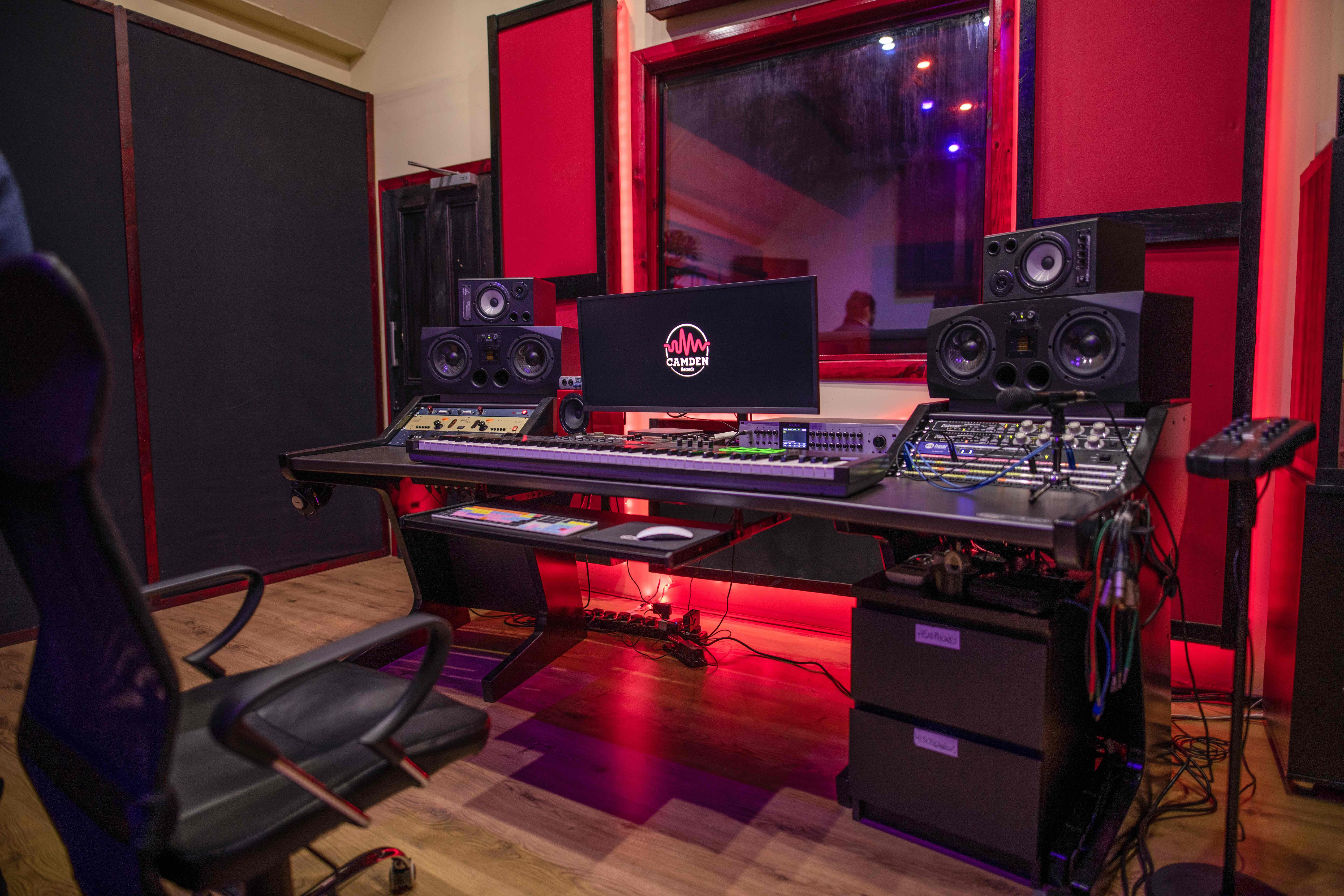 Modern recording studio with professional equipment for creative workshops and sound engineering.