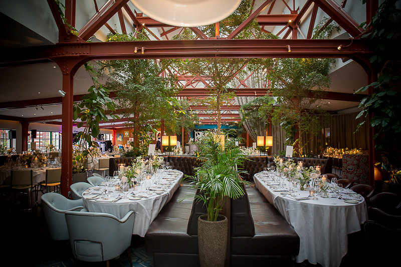 Elegant wedding setup at Bluebird Chelsea with lush greenery and natural light.