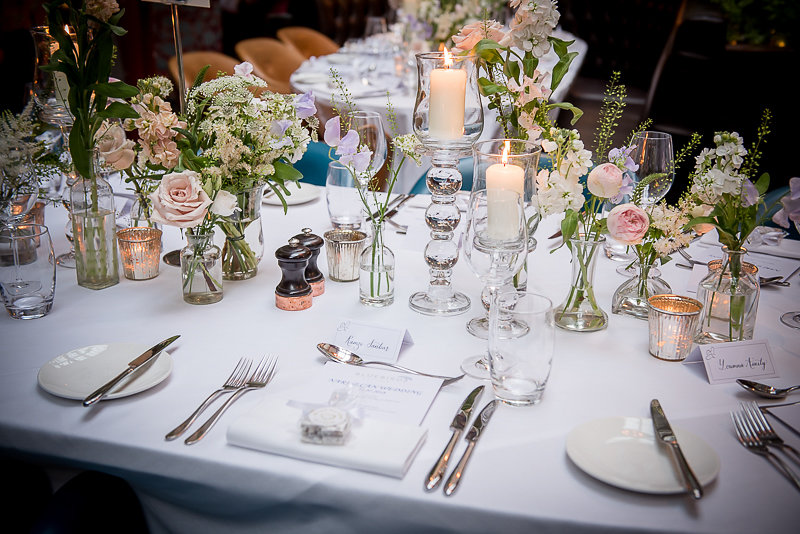 Elegant wedding dining table with floral centerpieces at Bluebird Chelsea.
