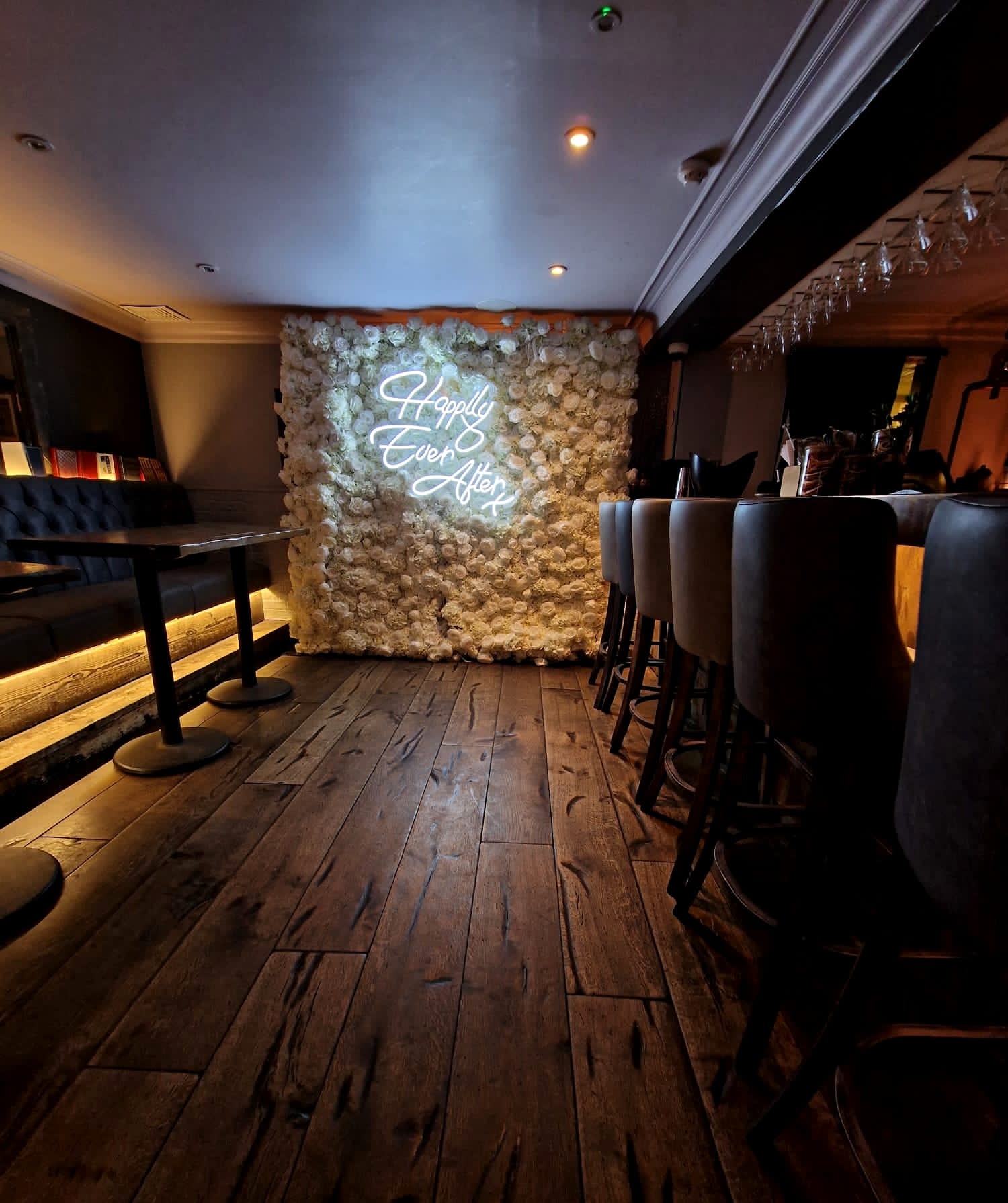 Stylish garden room with floral backdrop, perfect for weddings and celebrations.