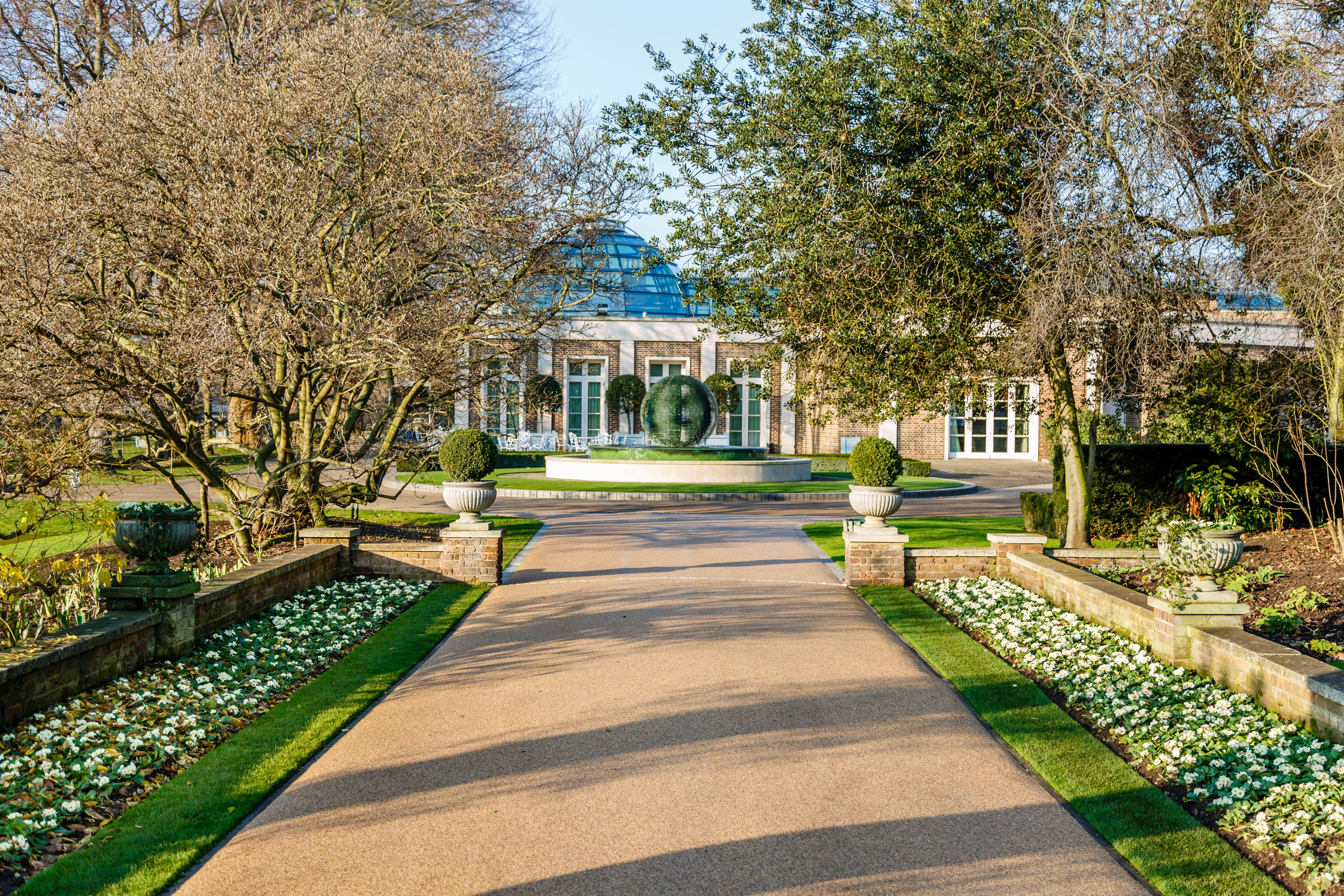 Luxury wedding venue entrance at The Hurlingham Club, featuring impeccable landscaping.