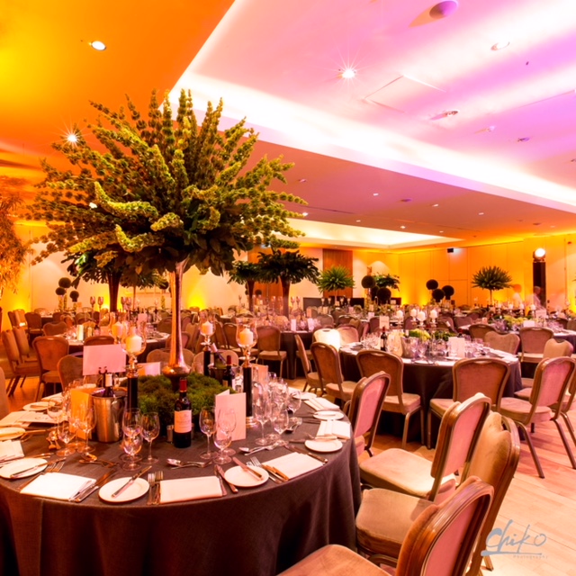 Elegant banquet hall with lush greenery centerpiece for sophisticated events at The Hurlingham Club.