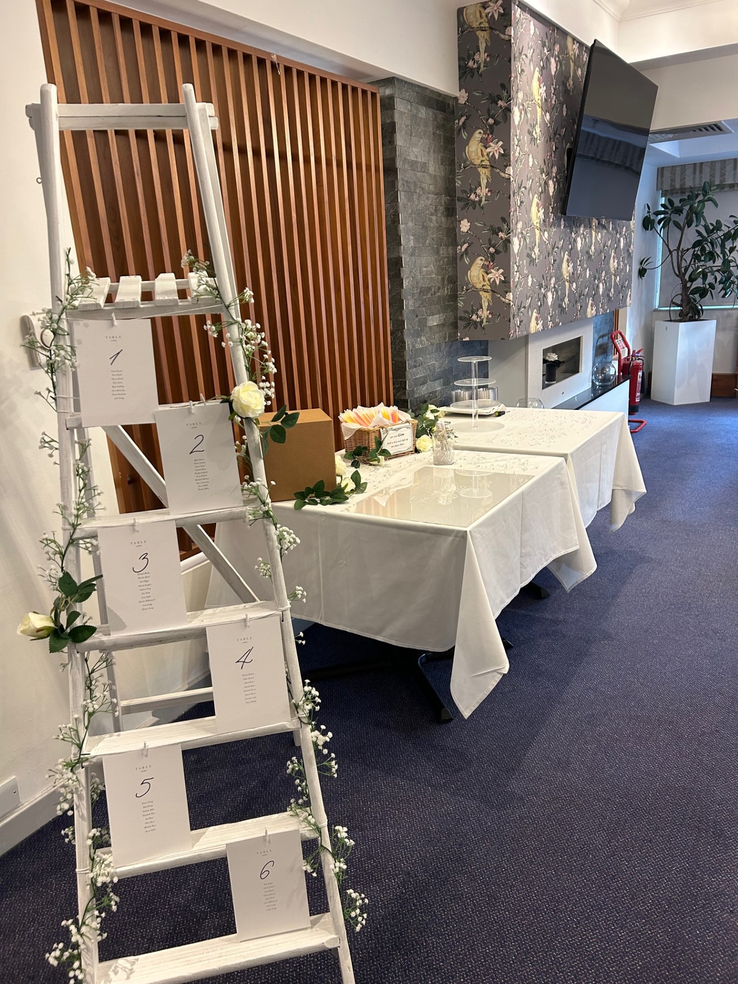 Event setup at Meon Valley Hotel with decorative ladder display and elegant tables.