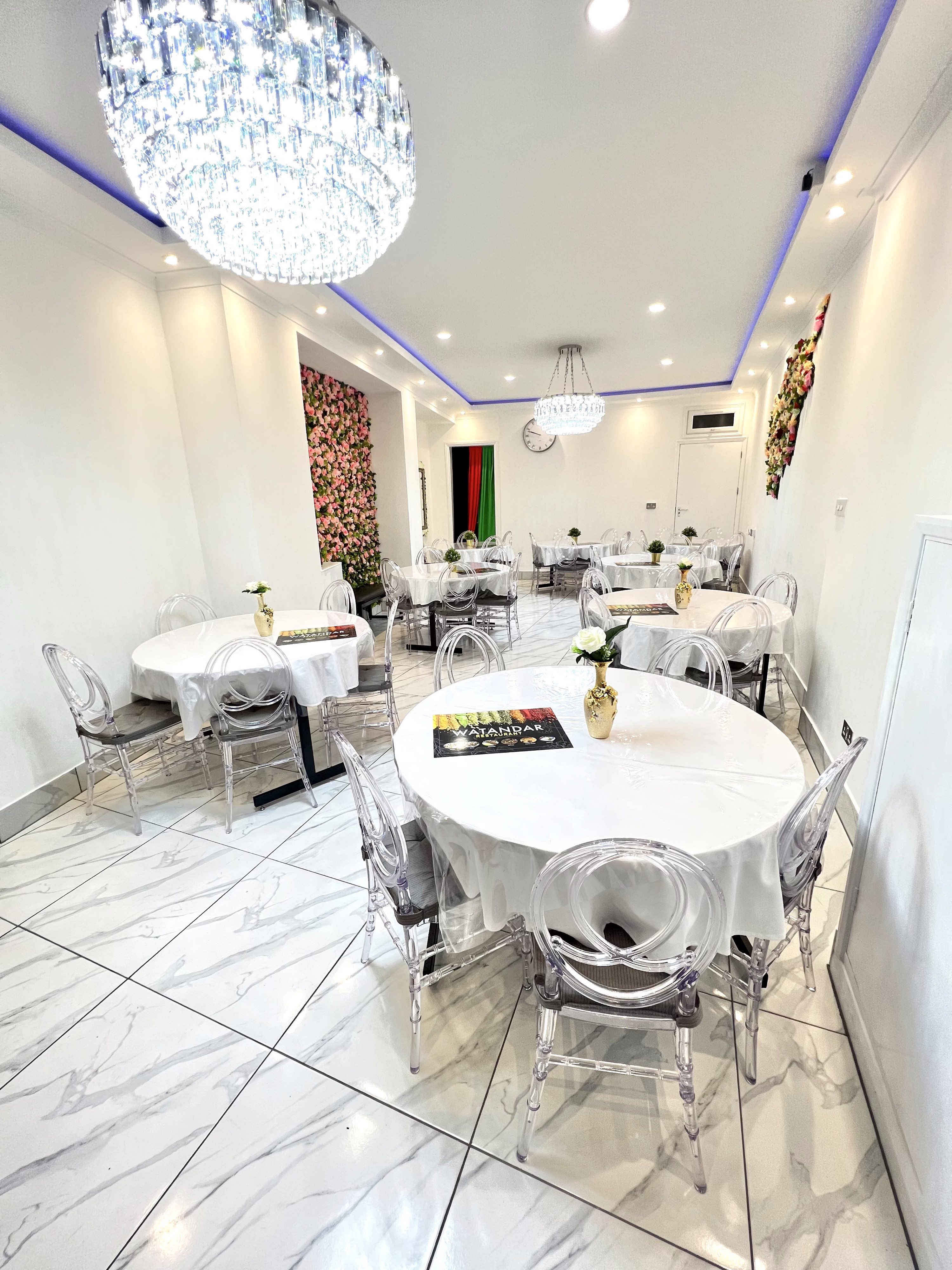 Elegant Watandar Hall event space with round tables, ideal for intimate gatherings and workshops.