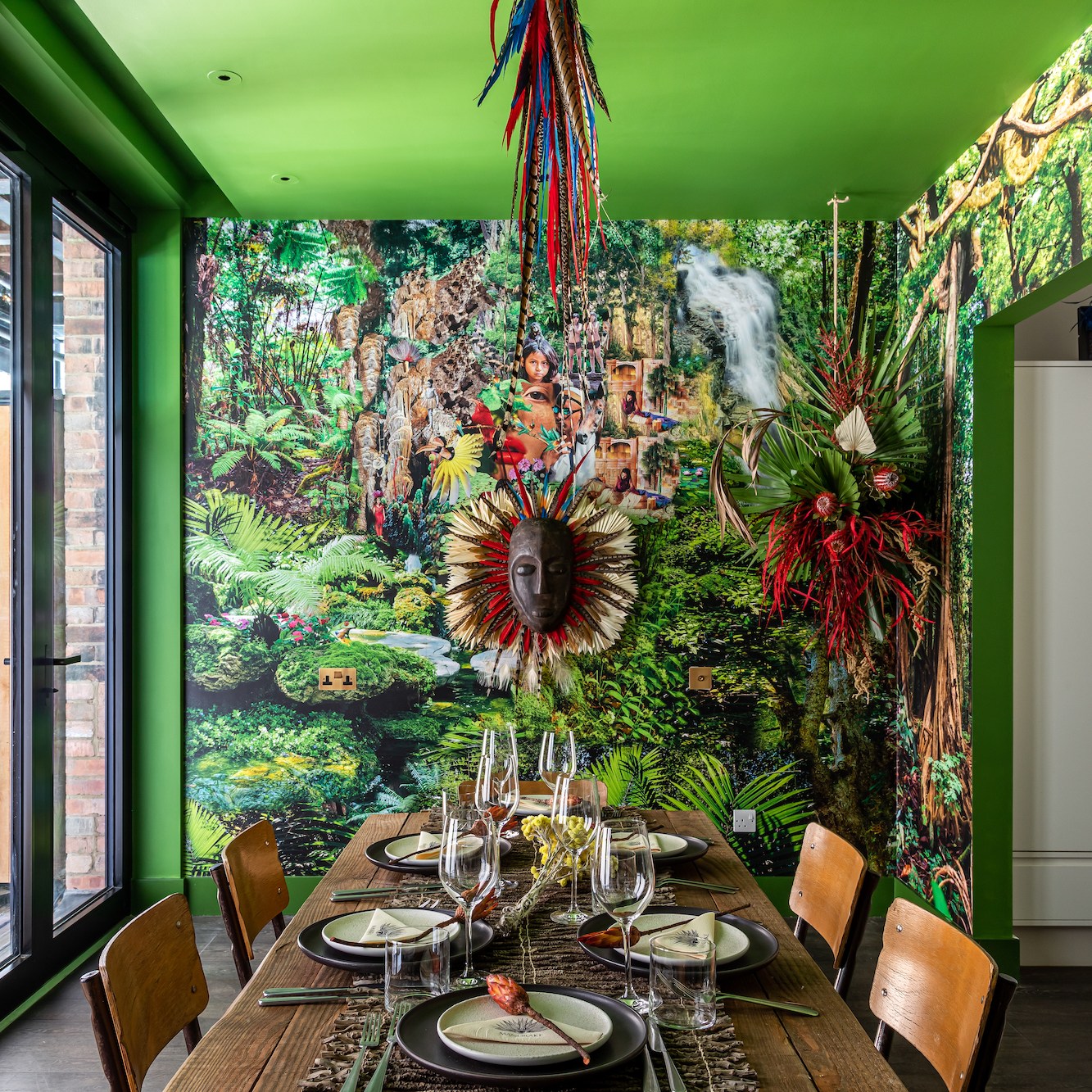 Private dining room with lush green mural ideal for creative meetings and unique dining events.