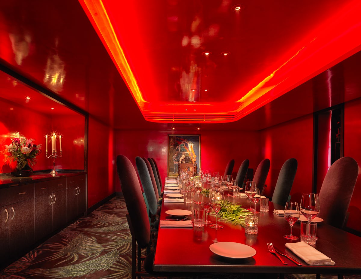 Private dining room at The Mandrake, elegant red decor for intimate events or meetings.