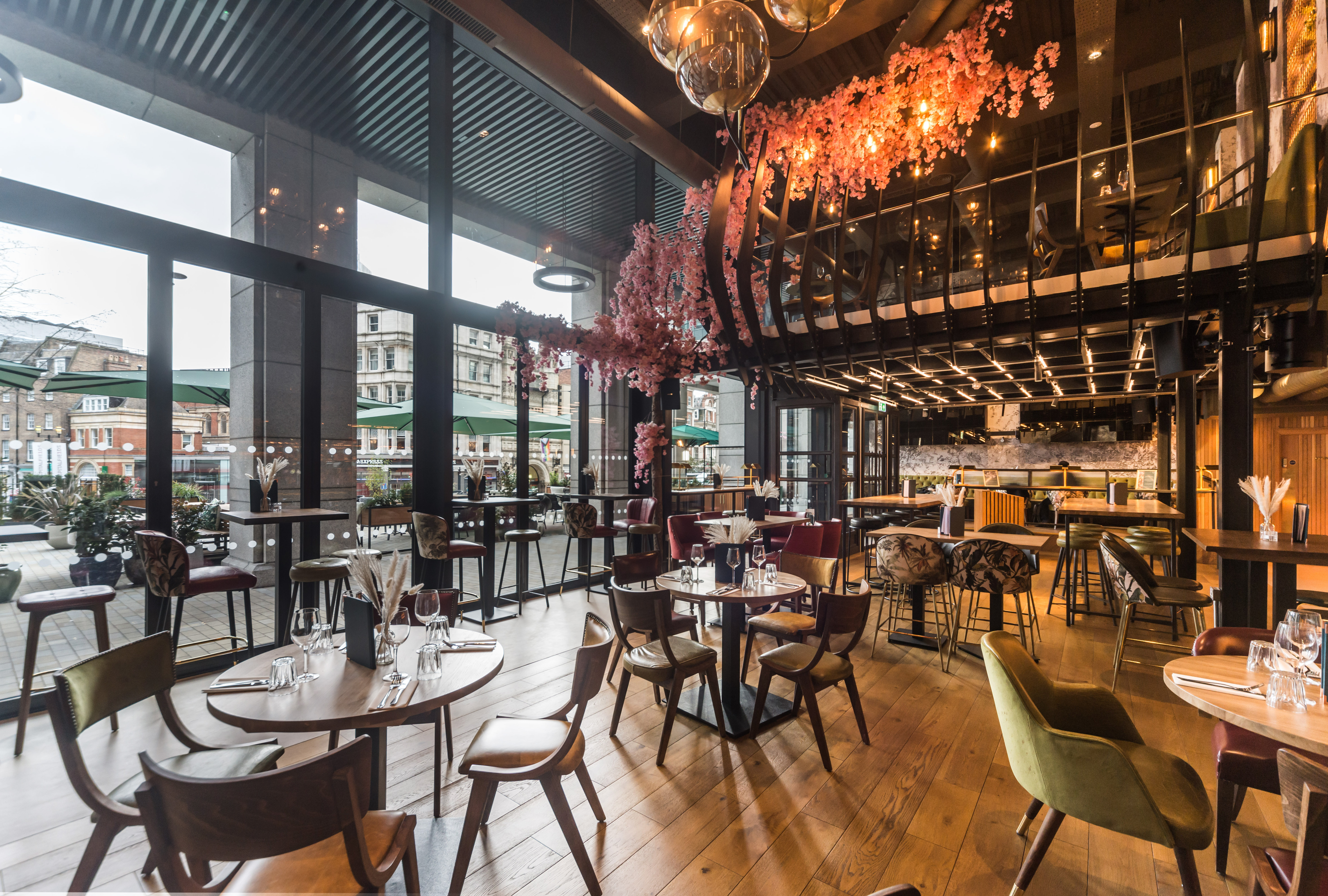 Modern event space at Nest Bishopsgate with elegant wooden flooring and floral decor.