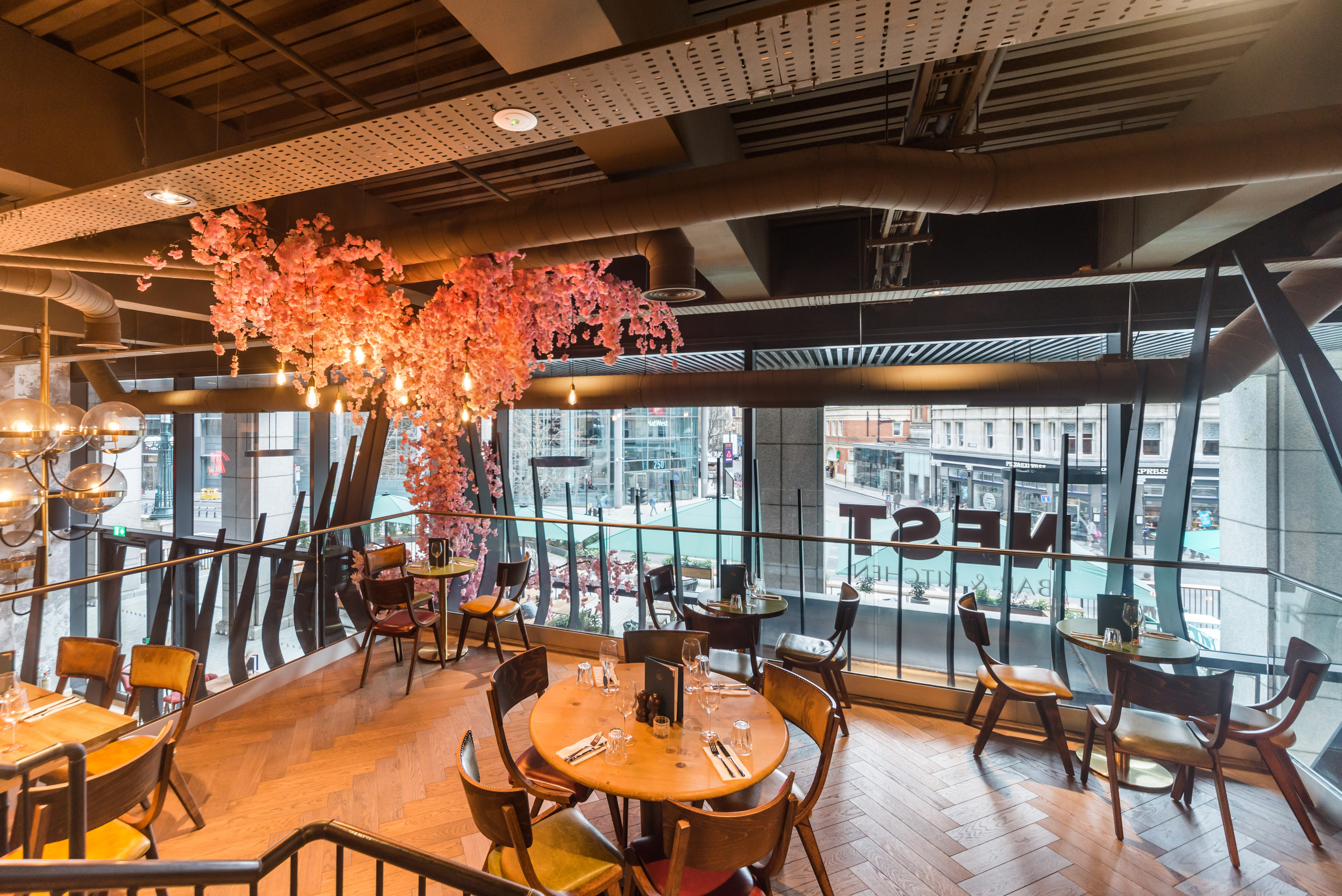 Modern dining space at Nest Bishopsgate with cherry blossom decor for events.
