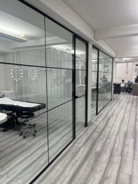 Modern event space in Beauty School Manchester with sleek glass partitions for workshops.