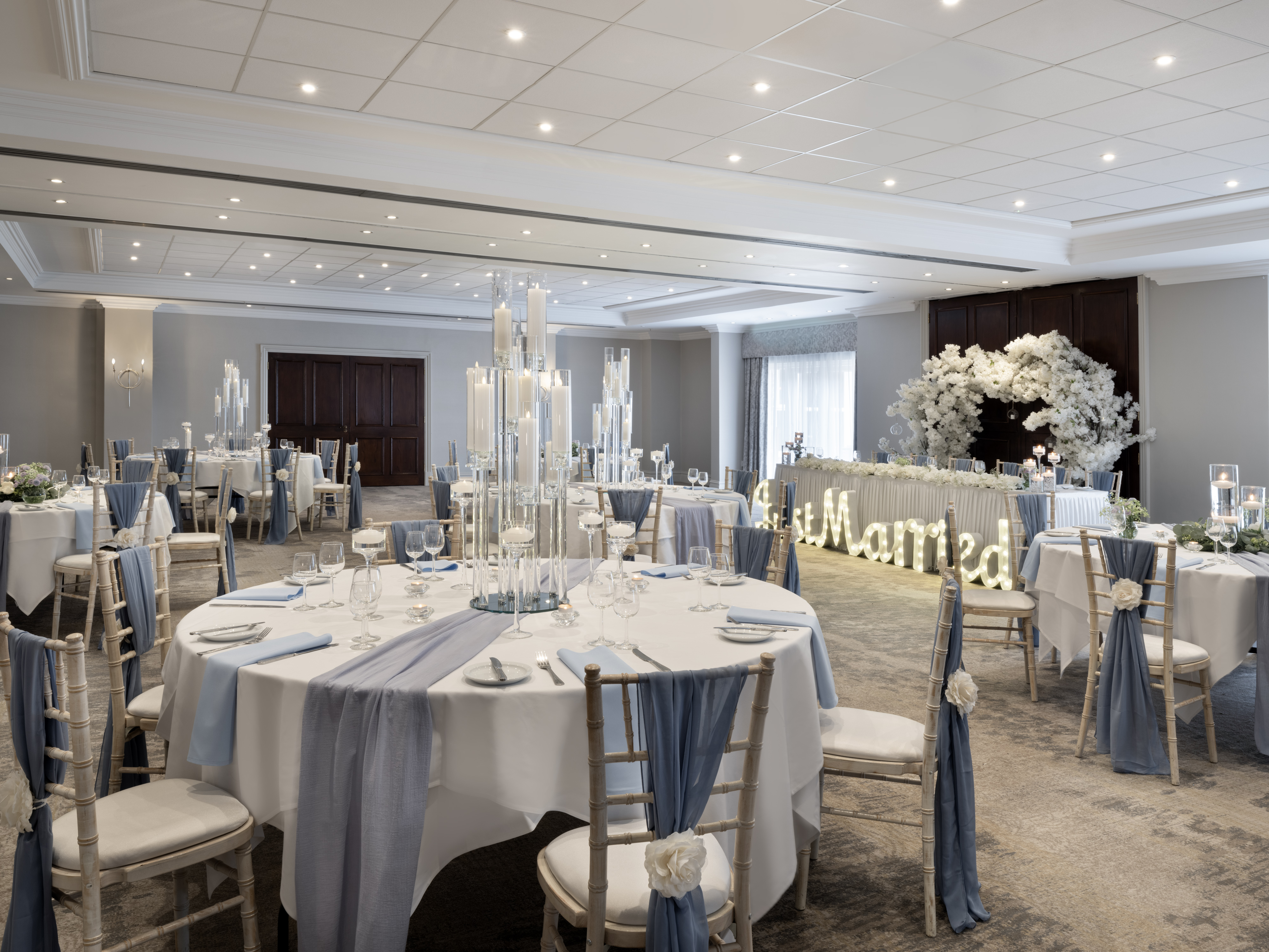 Worsley Suite at Delta Hotels, elegant wedding venue with blue accents and floral decor.