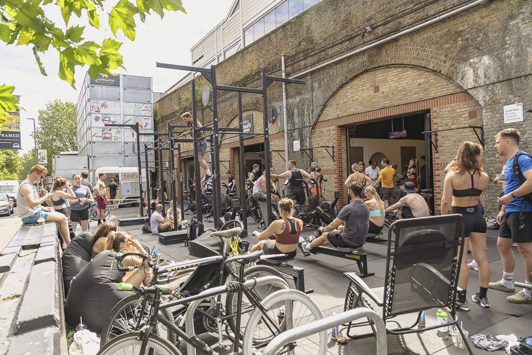 Outdoor CrossFit event at Shapesmiths, featuring diverse participants in an urban setting.
