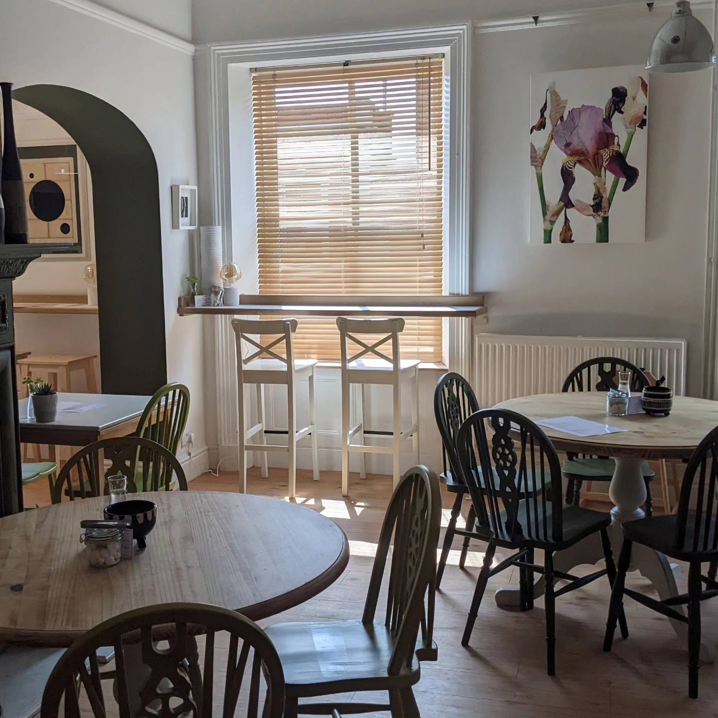 Bright meeting space at The George Cafe with natural light, ideal for gatherings and brainstorming.