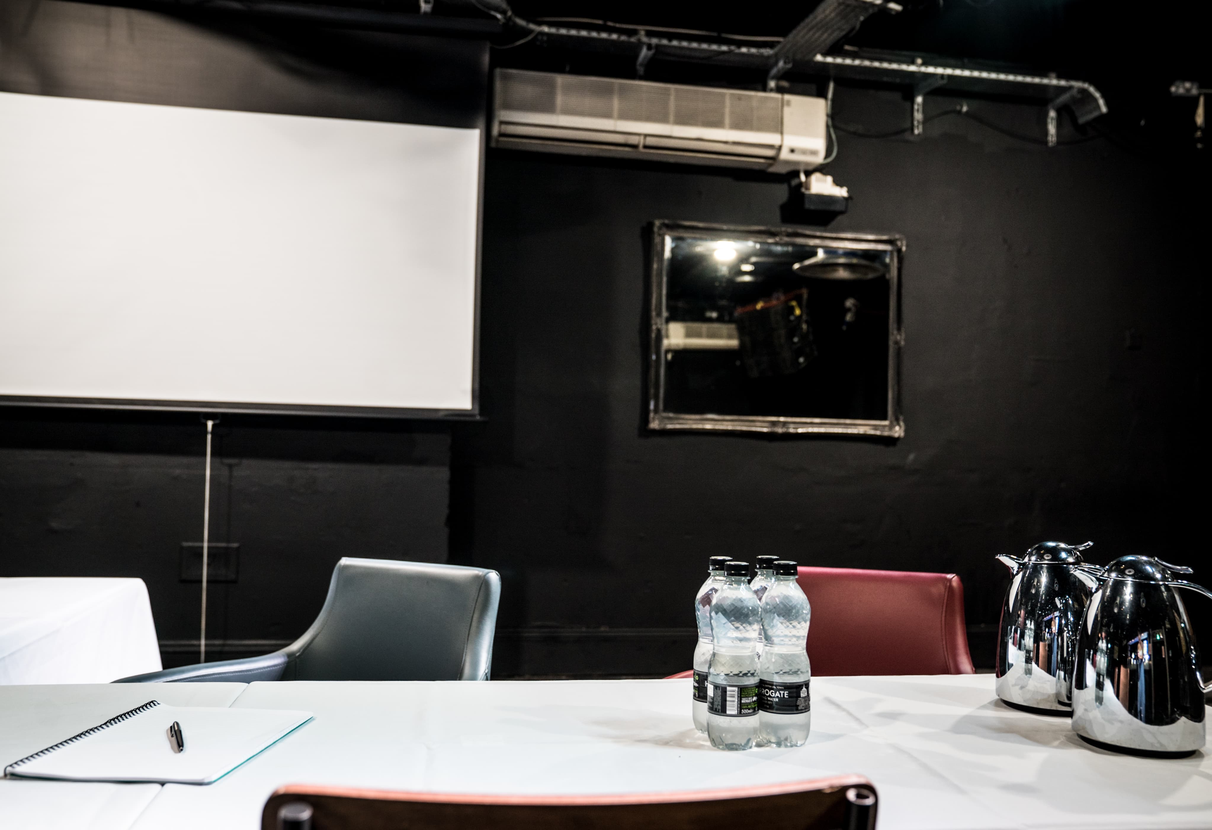 Corporate hire room in Brixton Jamm with minimalist setup for meetings and presentations.