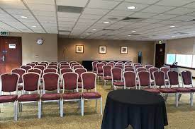 Pembroke Suite meeting space with burgundy chairs, ideal for conferences and events.