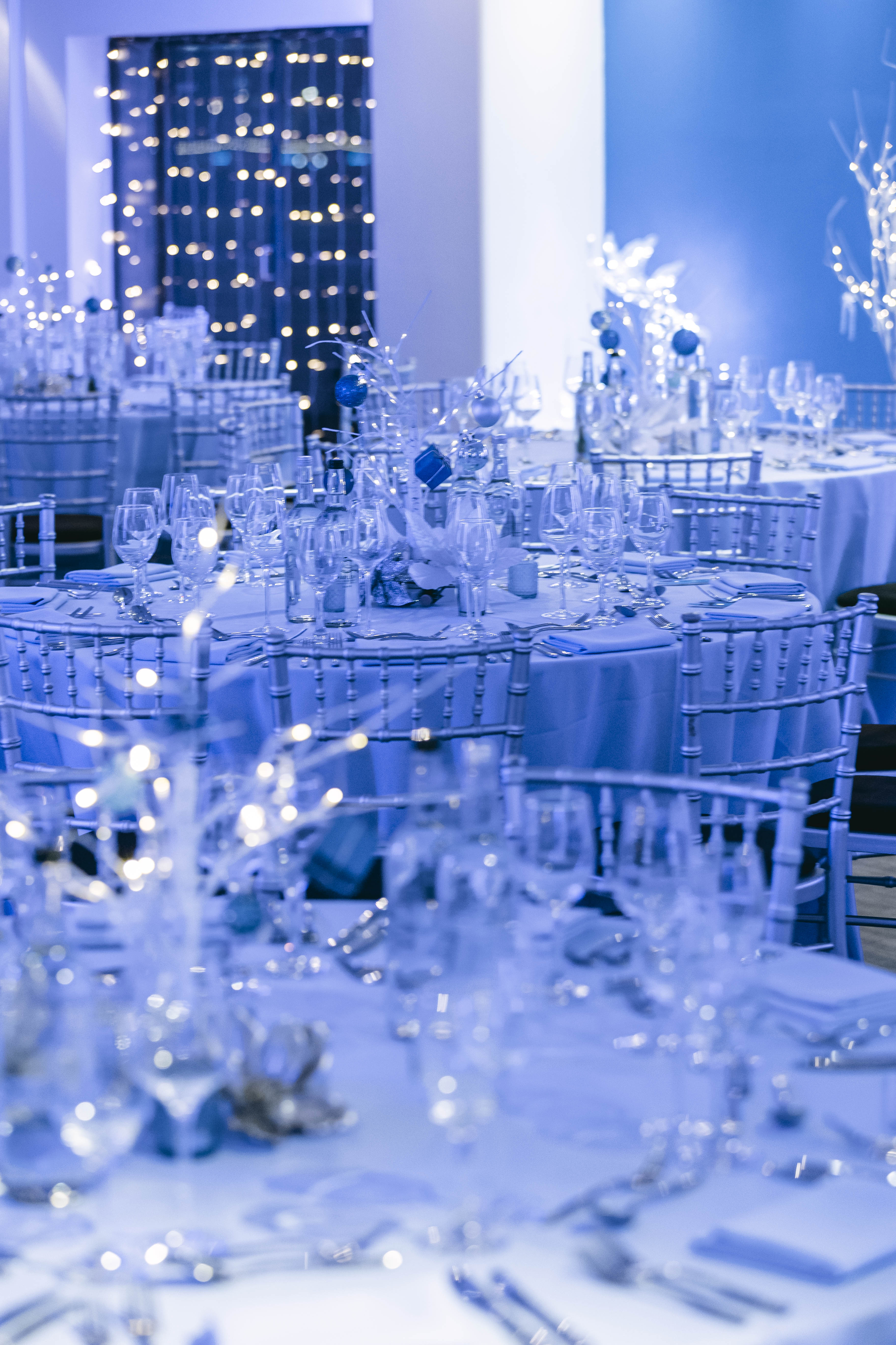 Elegant banquet space with blue linens, ideal for weddings and corporate galas.