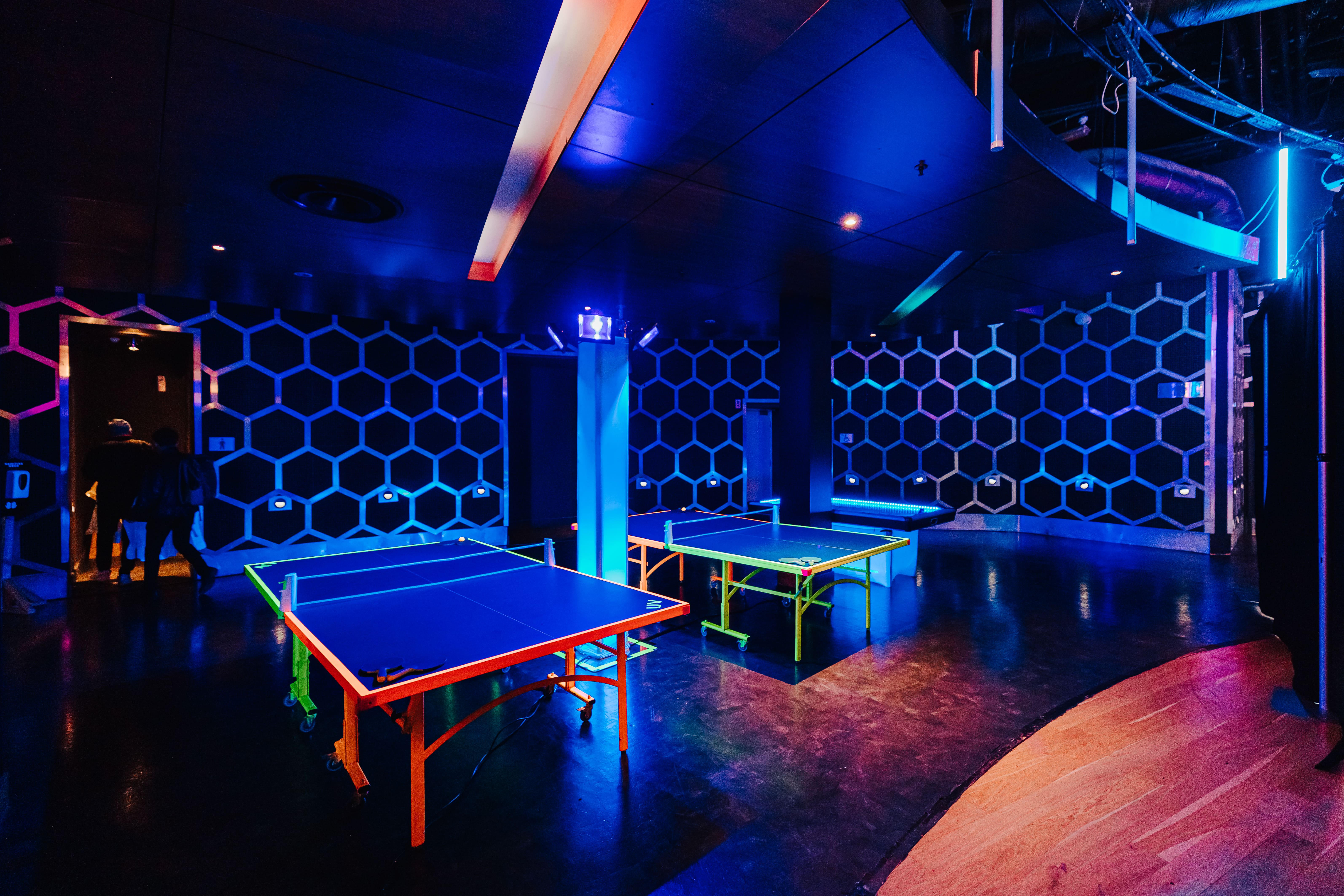 Vibrant event space with neon ping pong tables for Christmas networking at The O2.