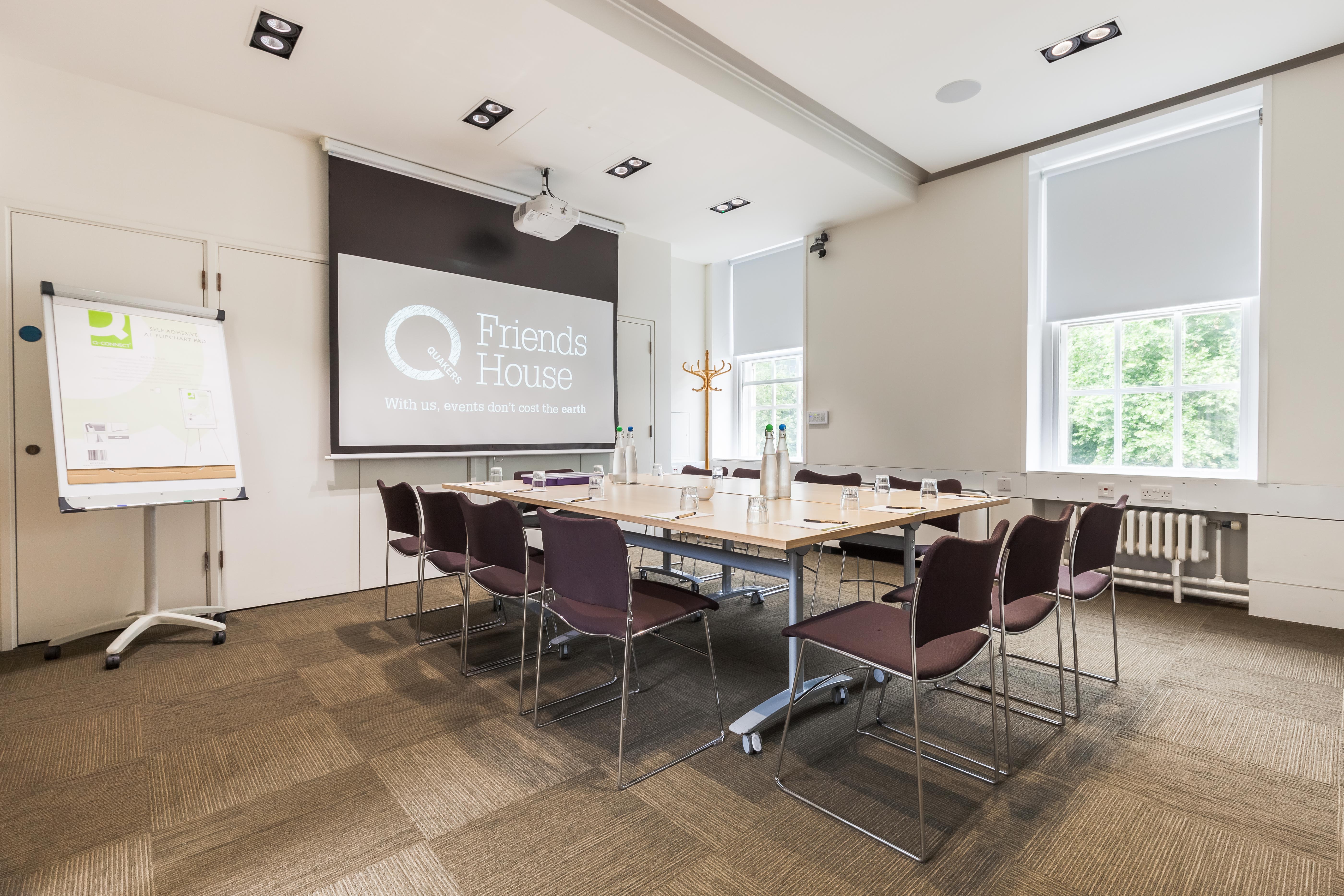 Hilda Clark Suite meeting room with central table, ideal for workshops and presentations.
