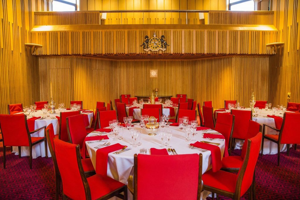 Main Hall gala dinner with red banquet seating for formal events and corporate ceremonies.